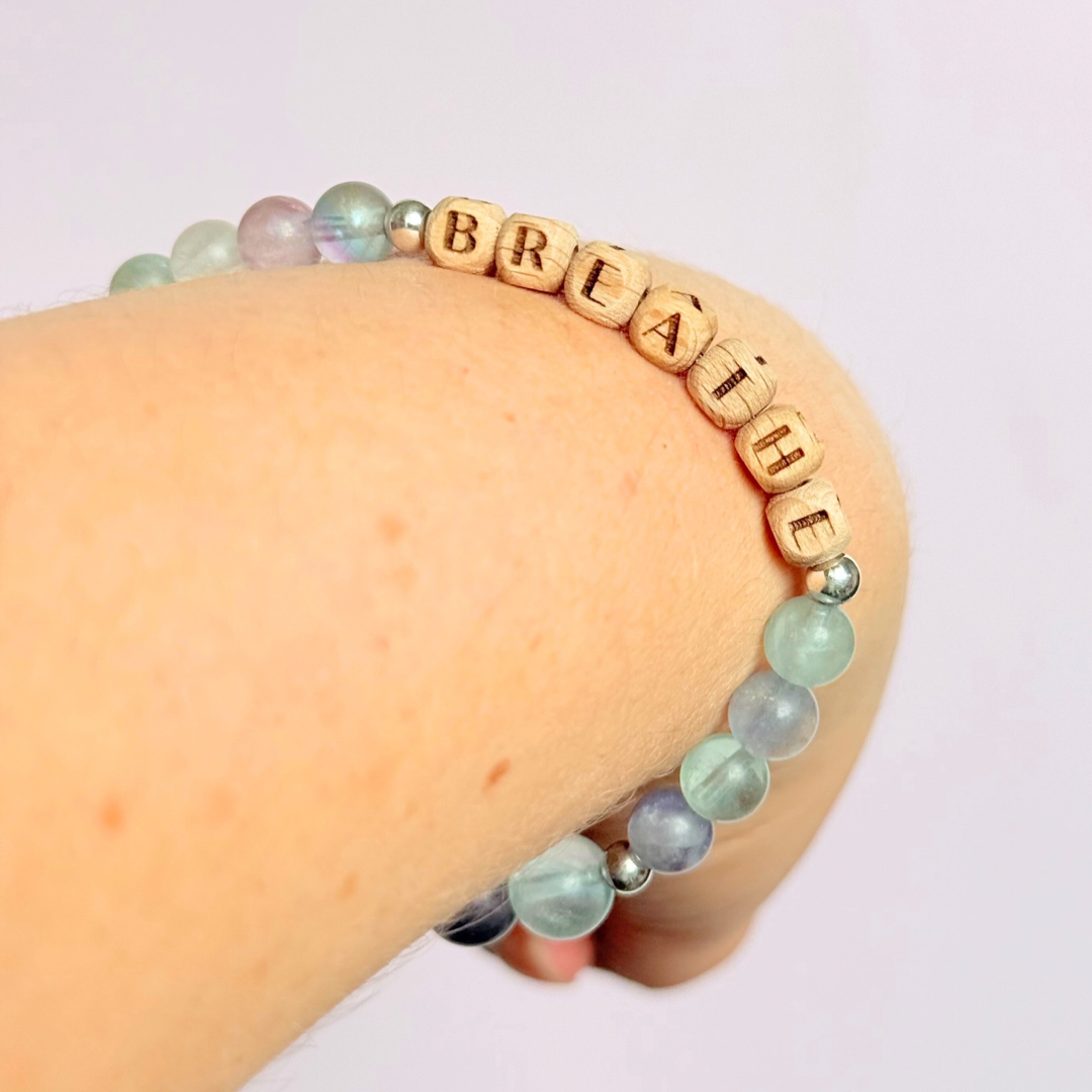 Breathwork bracelet featuring 6mm and 8mm frosted rainbow fluorite crystal beads that follow the 4-7-8 counted breathing method. Also featuring laser engraved wooden letter beads spelling out the word BREATHE. Choose your accent beads from rose gold vermeil, gold vermeil or sterling silver.