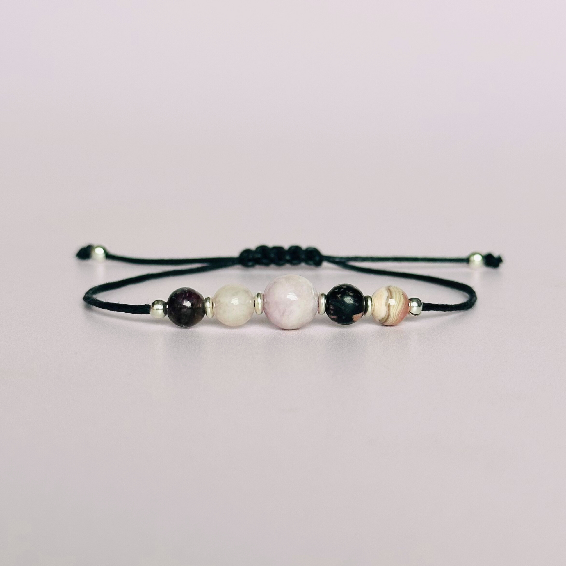 Cord bracelet made with five crystals all believed to help with self-love. Including kunzite, rubellite, rose quartz, rhodonite and rhodochrosite. With your choice of cord colour and choice of either sterling silver, gold vermeil or rose gold vermeil accent beads. Vegan friendly waxed cotton cord.