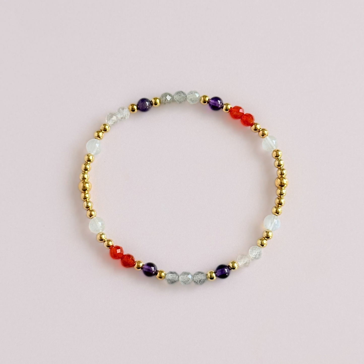 Dainty gold vermeil crystal bracelet featuring five crystals, in 4mm faceted and smooth round style, each believed to help with hormonal balance. Featuring amethyst, moonstone, carnelian, labradorite and rose quartz. Pictured from above.