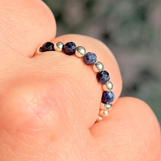 Sterling silver and sapphire crystal ring. Made with 2.5 mm sterling silver round beads and featuring five, 3mm faceted genuine sapphire beads in a band style. Perfect for stacking. September birthstone jewellery