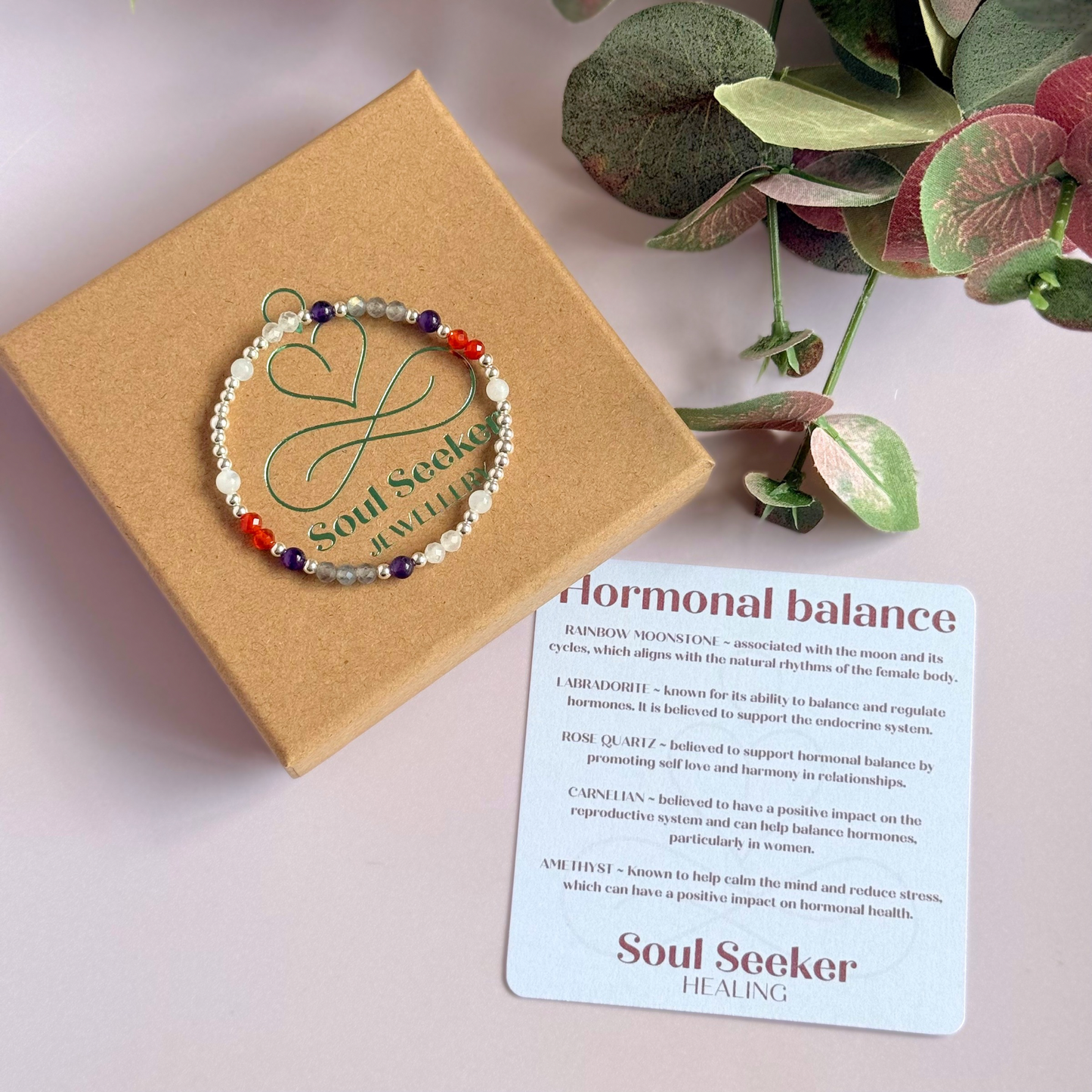 Dainty sterling silver crystal bracelet featuring five crystals, in 4mm faceted and smooth round style, each believed to help with hormonal balance. Featuring amethyst, moonstone, carnelian, labradorite and rose quartz. Pictured on the gift box, with the crystal information card.