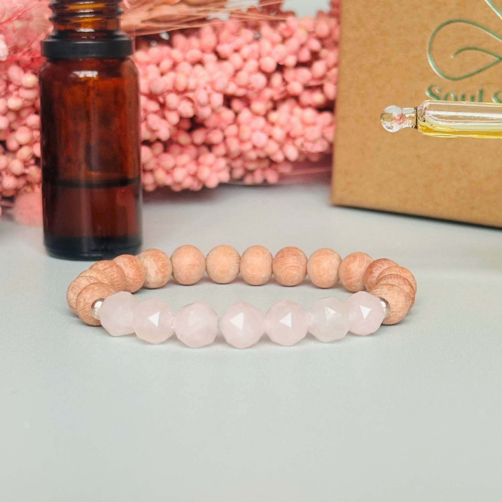 Rose quartz and raw rosewood elasticated essential oil diffuser bracelet. Made with 8mm star cut rose quartz beads, 8mm round raw rosewood beads and your choice of sterling silver, gold vermeil or rose gold vermeil spacer beads