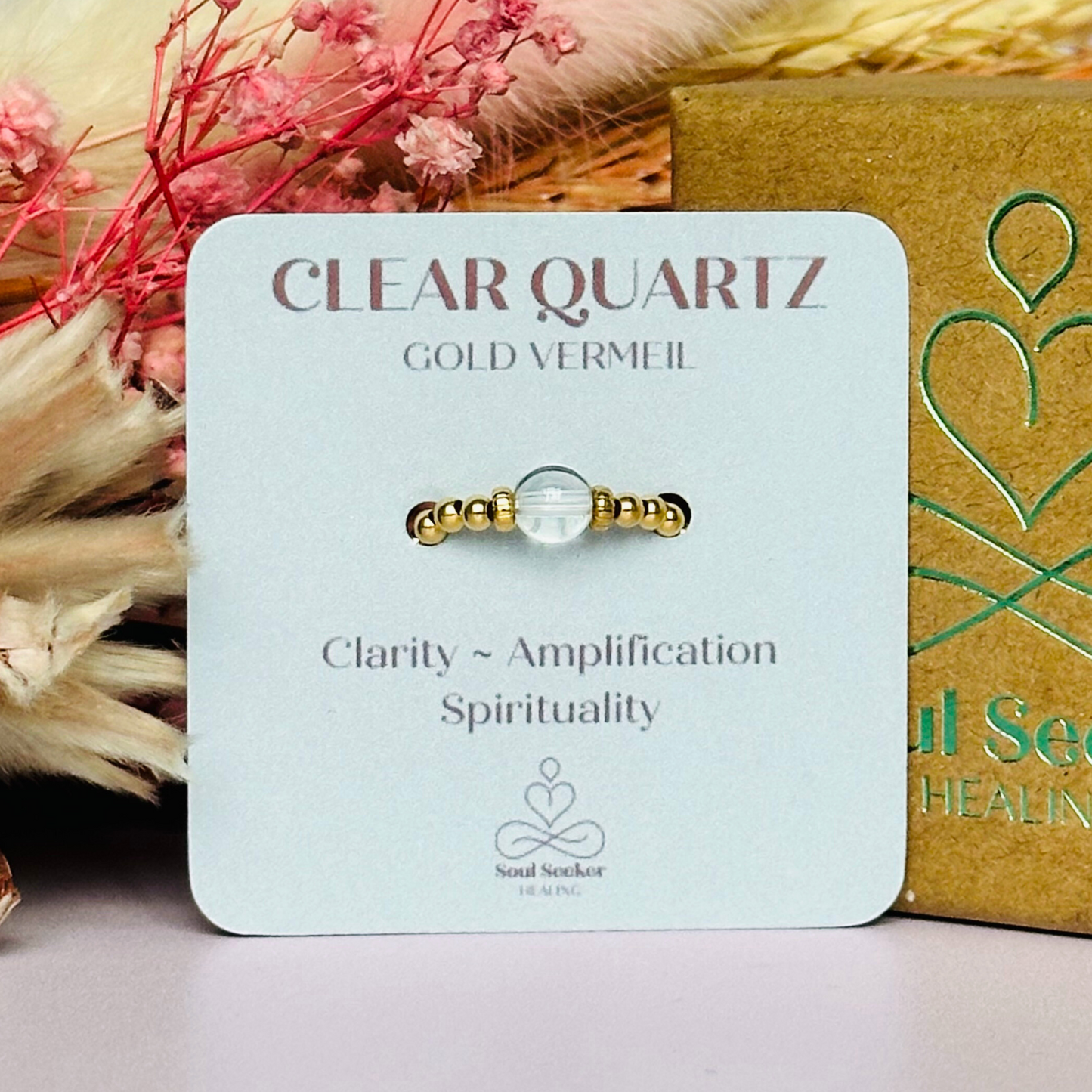 This gold vermeil clear quartz ring features a 6mm round ethically sourced clear quartz bead, surrounded by gold vermeil corrugated rondelle beads and delicate 2.5mm gold vermeil beads. April birthstone ring.