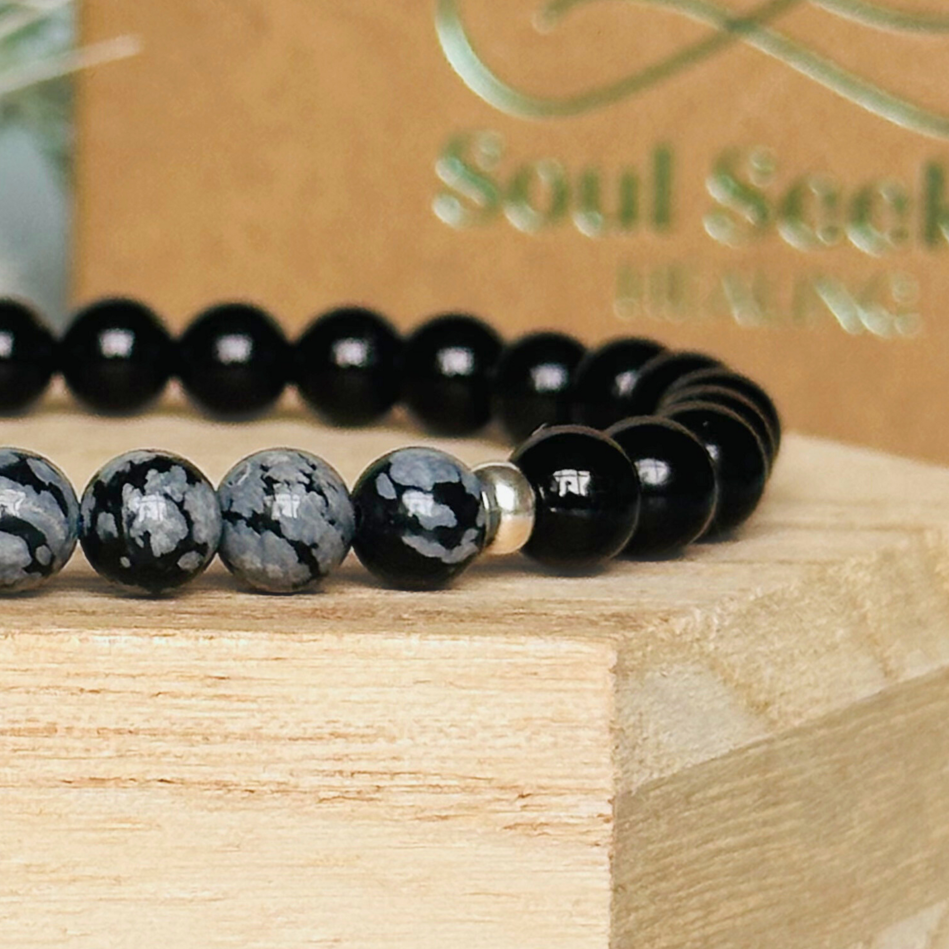 Men’s crystal bracelet featuring 6mm black tourmaline beads, 6mm snowflake obsidian beads with sterling silver spacer beads.