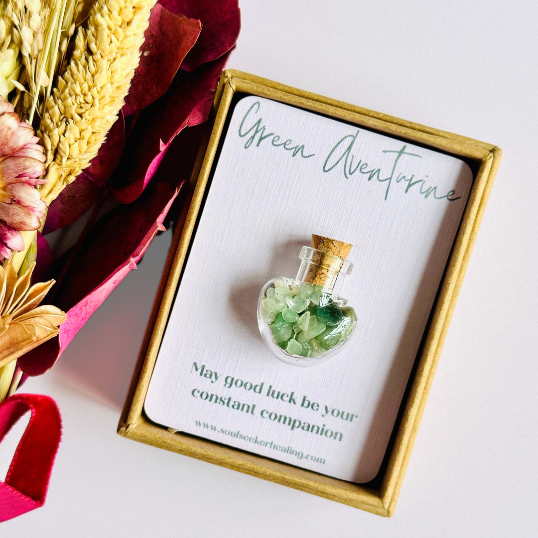 A pretty heart shaped mini glass bottle filled with powerful, ethically mined green aventurine crystal chips, known for their properties regarding good luck, abundance and success. Presented on a card with the words ‘may good luck be your constant companion.’ This bottle measures approximately 28mm x 23mm, including cork when it is pushed in.