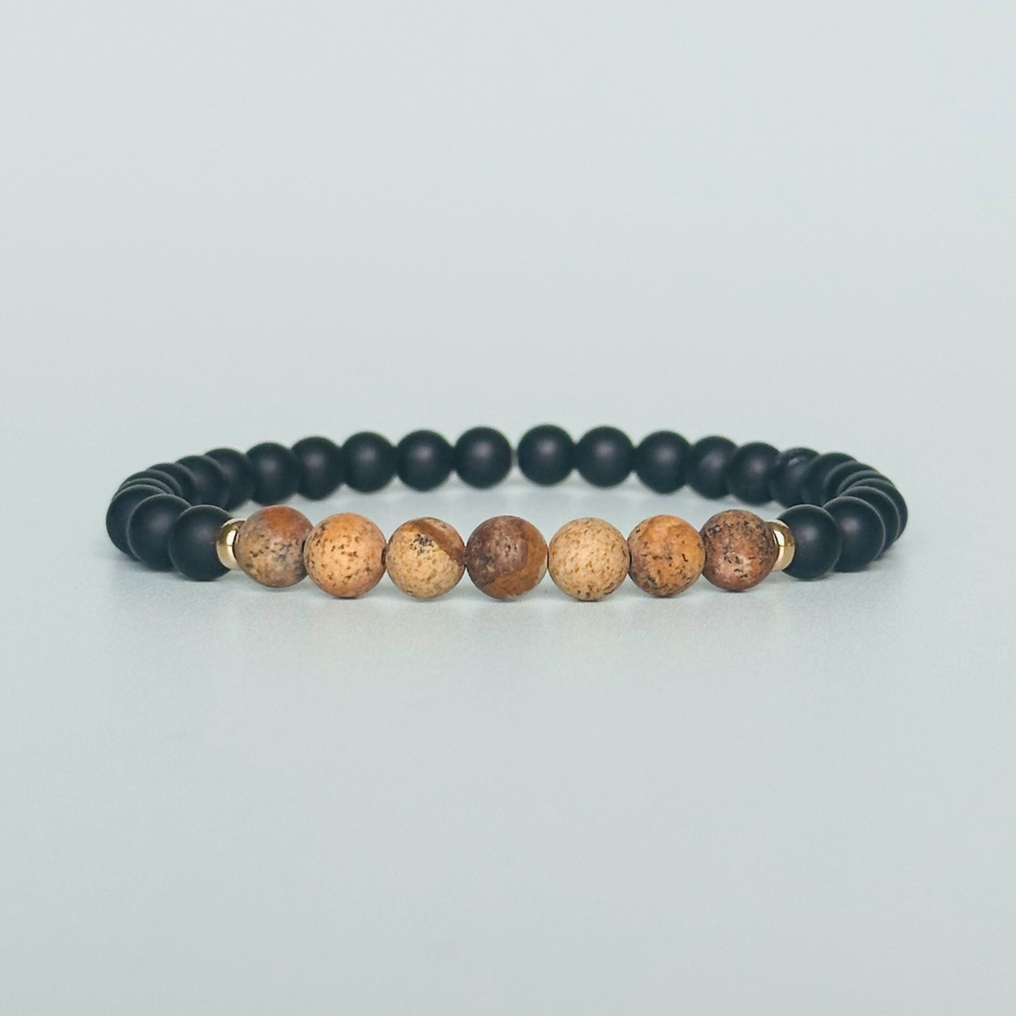 Men’s crystal bracelet featuring 6mm matte black onyx beads, 6mm matte picture jasper beads with gold vermeil spacer beads.