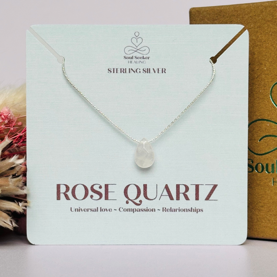 Dainty rose quartz teardrop necklace featuring a 12x8mm faceted rose quartz teardrop bead on a fine sterling silver beading chain.