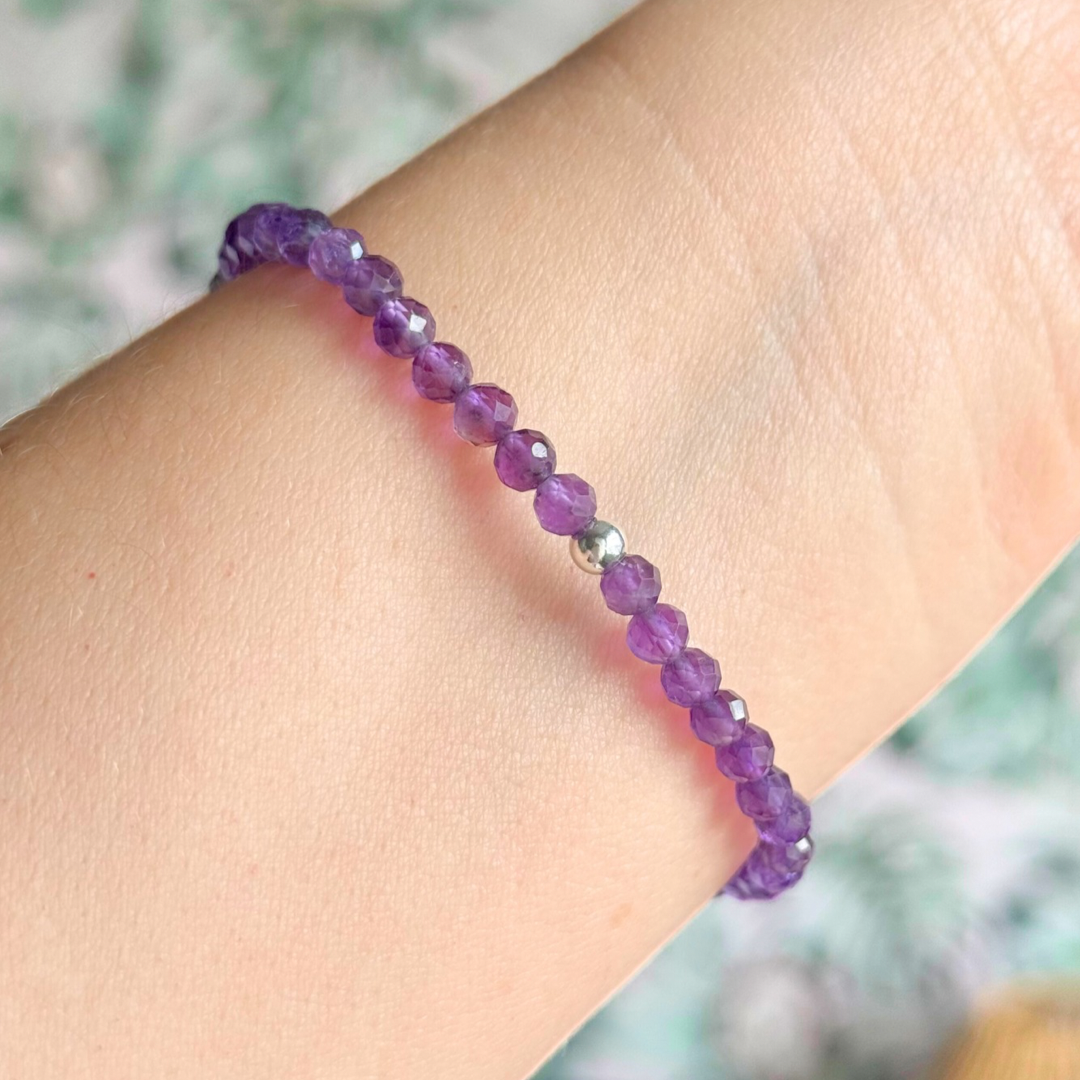 Bracelet featuring engraved wooden 333 angel number and wing beads, on the band of 4mm faceted amethyst round crystal gemstone beads. Finished with your choice of gold vermeil, sterling silver or rose gold vermeil accent beads.