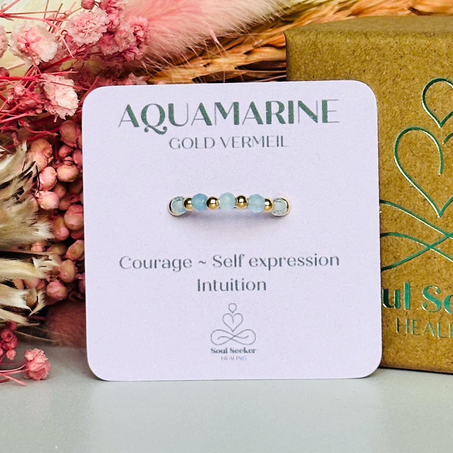 Gold vermeil aquamarine ring featuring five 3mm faceted round aquamarine beads on a elasticated ring band of 2.5mm gold vermeil beads. March birthstone ring.