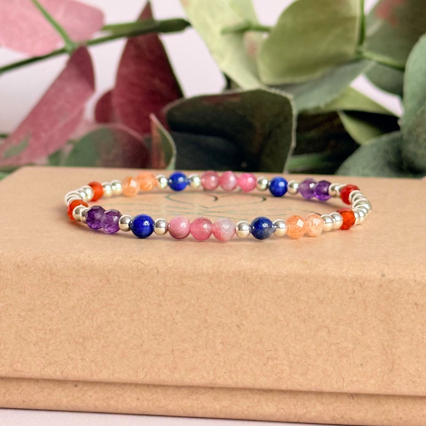 ‘Arabian Sunset' sterling silver dainty beaded bracelet with pink tourmaline, sunstone, carnelian, lapis lazuli and amethyst. Made with round 3mm sterling silver beads and 4mm smooth and faceted round crystal gemstone beads. Pictured on top of the gift box