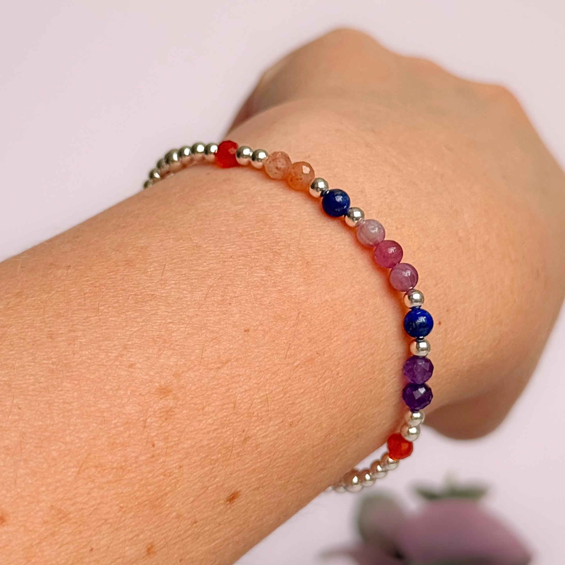 ‘Arabian Sunset' sterling silver dainty beaded bracelet with pink tourmaline, sunstone, carnelian, lapis lazuli and amethyst. Made with round 3mm sterling silver beads and 4mm smooth and faceted round crystal gemstone beads. Pictured being worn, at an angle