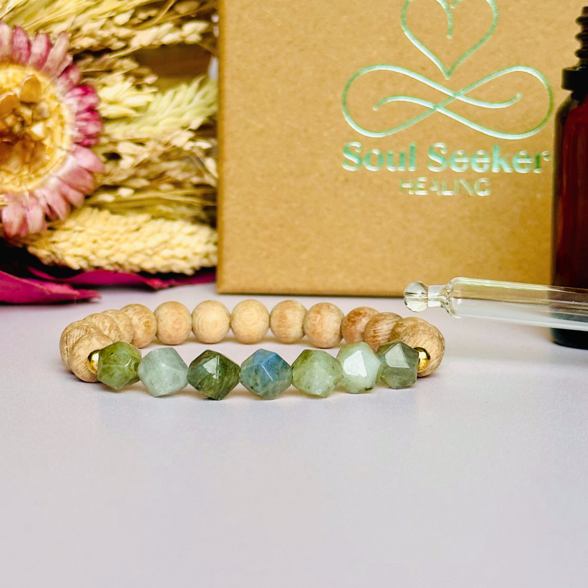 Labradorite and raw rosewood elasticated essential oil diffuser bracelet. Made with 8mm star cut labradorite beads, 8mm round raw rosewood beads and your choice of sterling silver, gold vermeil or rose gold vermeil spacer beads