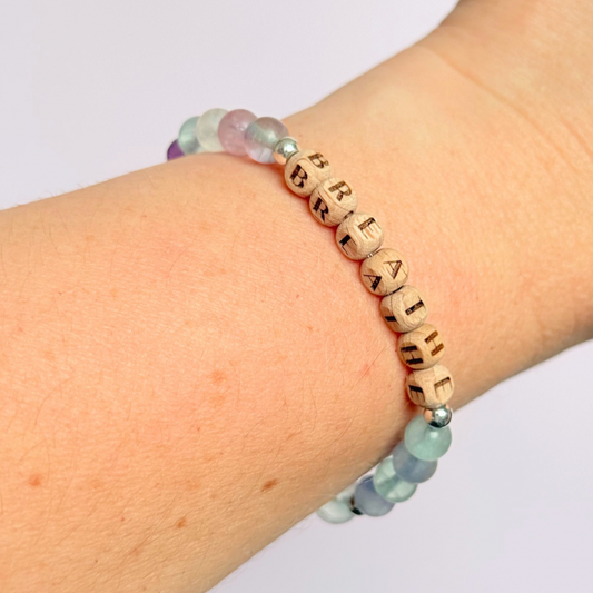 Breathwork bracelet featuring 6mm and 8mm frosted rainbow fluorite crystal beads that follow the 4-7-8 counted breathing method. Also featuring laser engraved wooden letter beads spelling out the word BREATHE. Choose your accent beads from rose gold vermeil, gold vermeil or sterling silver.