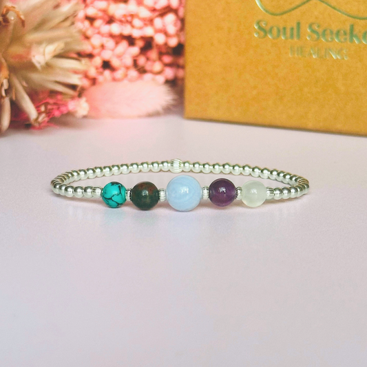 This sterling silver Pisces bracelet is made with a selection of five healing crystals all believed to resonate with the Pisces zodiac sign. The central bead is 8mm, the other four are 6mm. On an elasticated band of 3mm sterling silver beads with corrugated accent beads. Featuring turquoise, bloodstone, blue lace agate, amethyst and selenite.