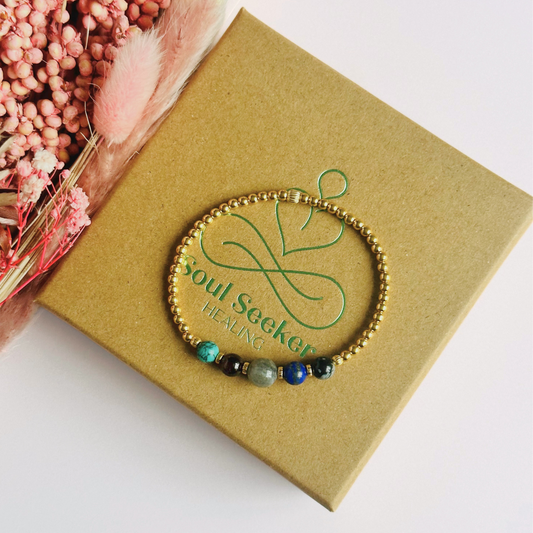 This gold vermeil Sagittarius bracelet is made with a selection of five healing crystals all believed to resonate with the Sagittarius zodiac sign. The central bead is 8mm, the other four are 6mm. On an elasticated band of 3mm gold vermeil beads with corrugated accent beads. Featuring garnet, labradorite, lapis lazuli, snowflake obsidian and turquoise.