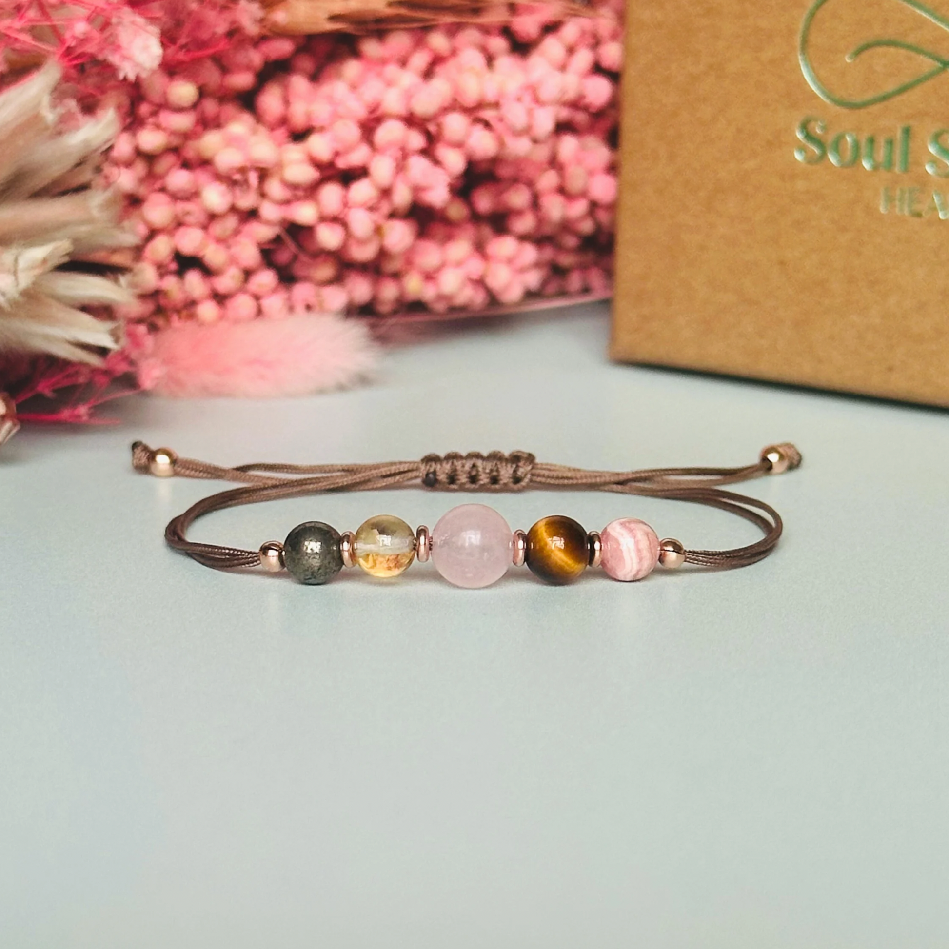 Cord bracelet made with five crystals all believed to help with self-confidence. Including pyrite, citrine, rose quartz, tigers eye and rhodochrosite. With your choice of cord colour and choice of either sterling silver, gold vermeil or rose gold vermeil accent beads.￼