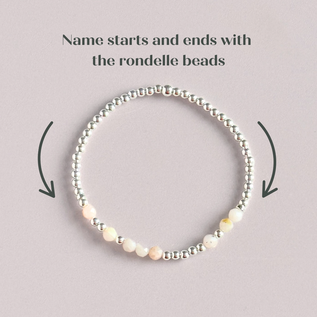Morse code secret message bracelet spelling out your chosen name in sterling silver and pink opal crystal beads. Elasticated with 4mm faceted pink opal beads and 3mm sterling silver beads. Custom October birthstone bracelet.