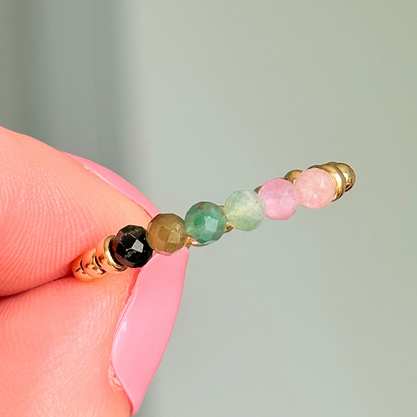 Gold vermeil band style ring with multicolour 3mm faceted mixed tourmaline beads in shades of pink, green and black, with a beaded band of 2.5 mm gold vermeil round beads. Elasticated for comfort.