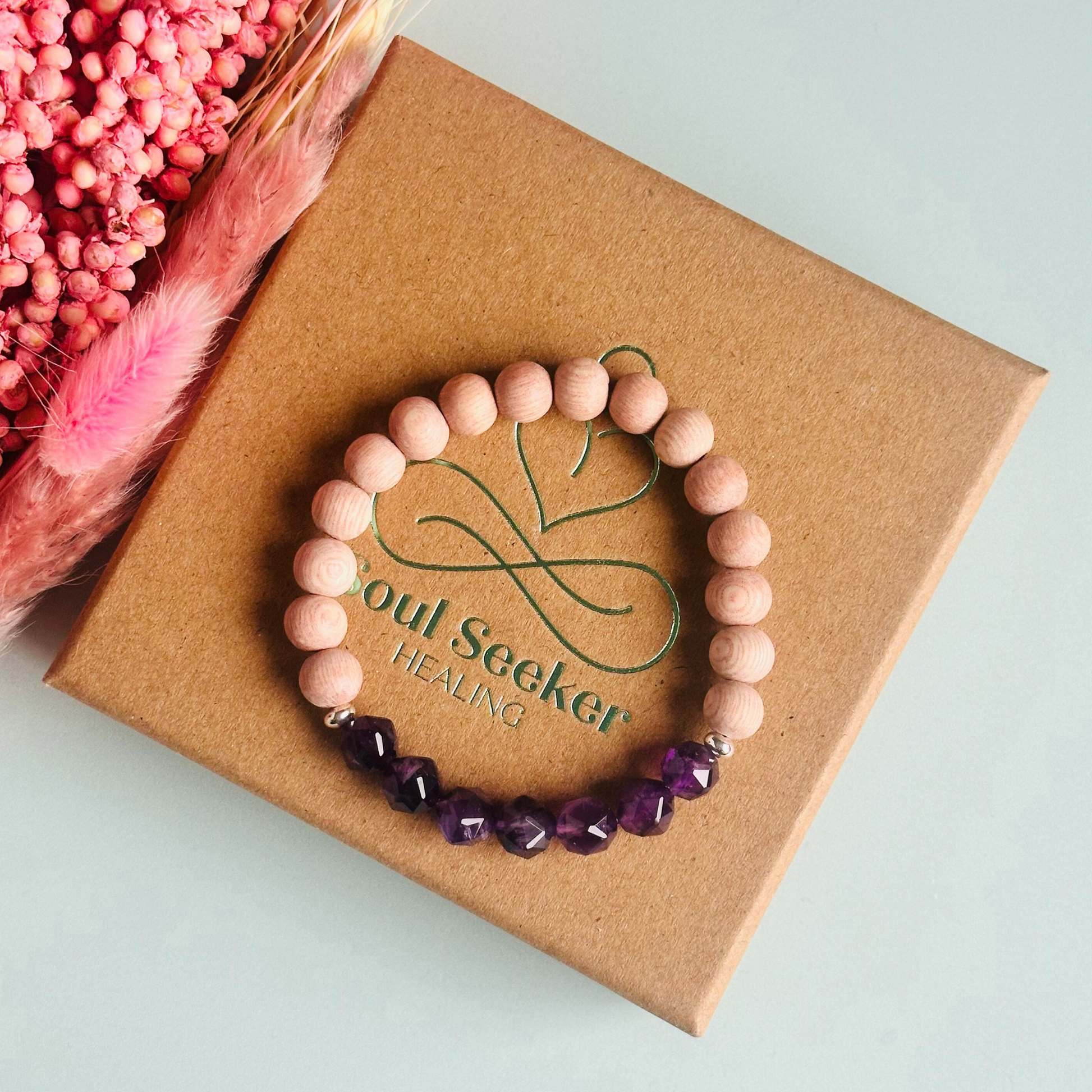Amethyst and raw rosewood elasticated essential oil diffuser bracelet. Made with 8mm star cut amethyst beads, 8mm round raw rosewood beads and your choice of sterling silver, gold vermeil or rose gold vermeil spacer beads
