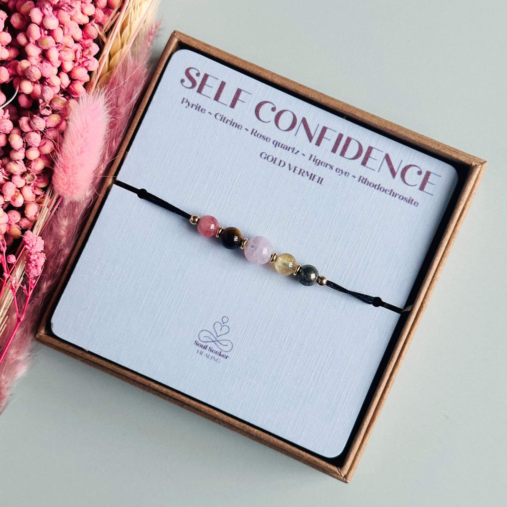 Cord bracelet made with five crystals all believed to help with self-confidence. Including pyrite, citrine, rose quartz, tigers eye and rhodochrosite. With your choice of cord colour and choice of either sterling silver, gold vermeil or rose gold vermeil accent beads.