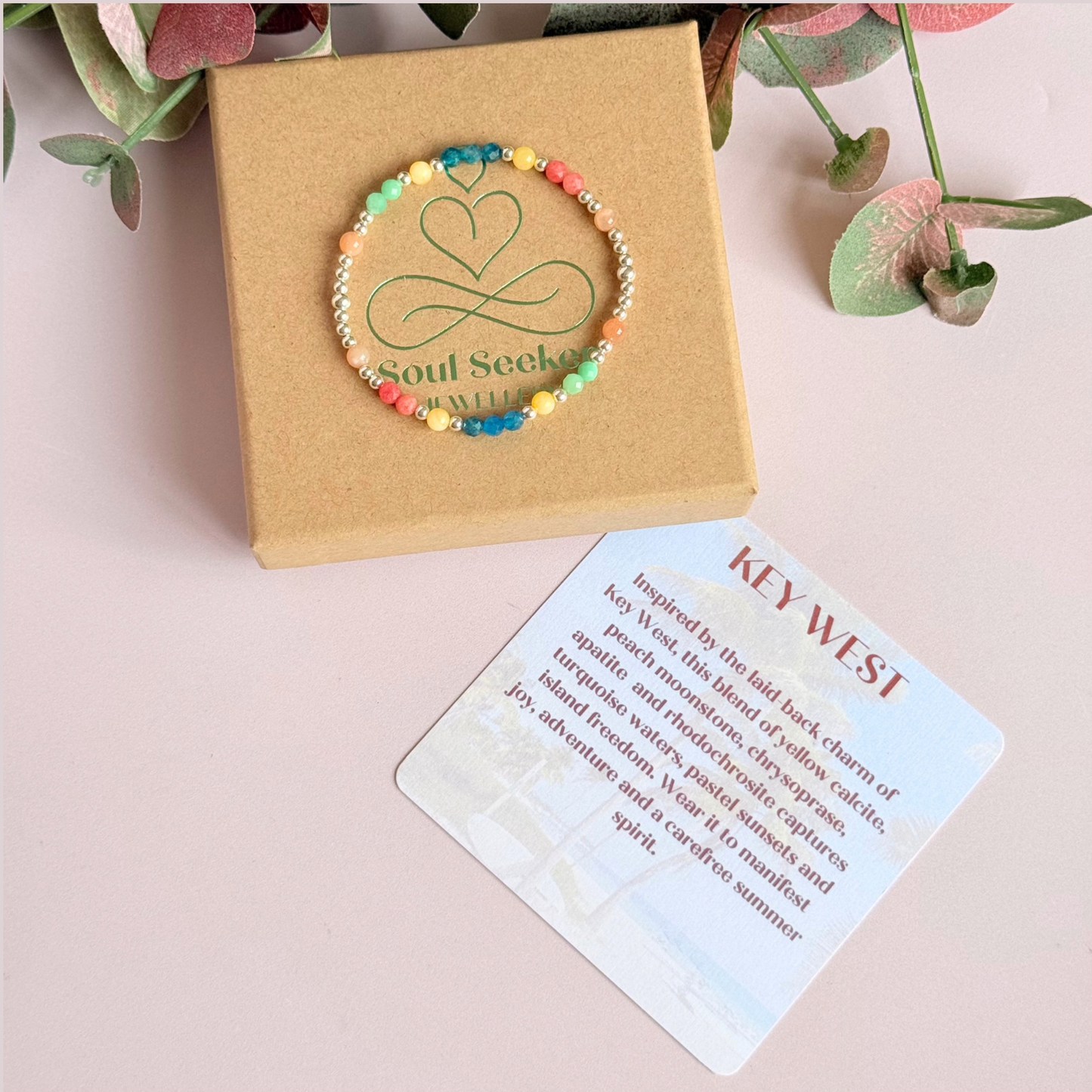 'Key West' sterling silver dainty beaded bracelet with apatite, rhodochrosite, yellow calcite, chrysoprase and peach moonstone. Made with round 3mm sterling silver beads and 4mm smooth and faceted round crystal gemstone beads. Pictured on top of the gift box with the crystal information card