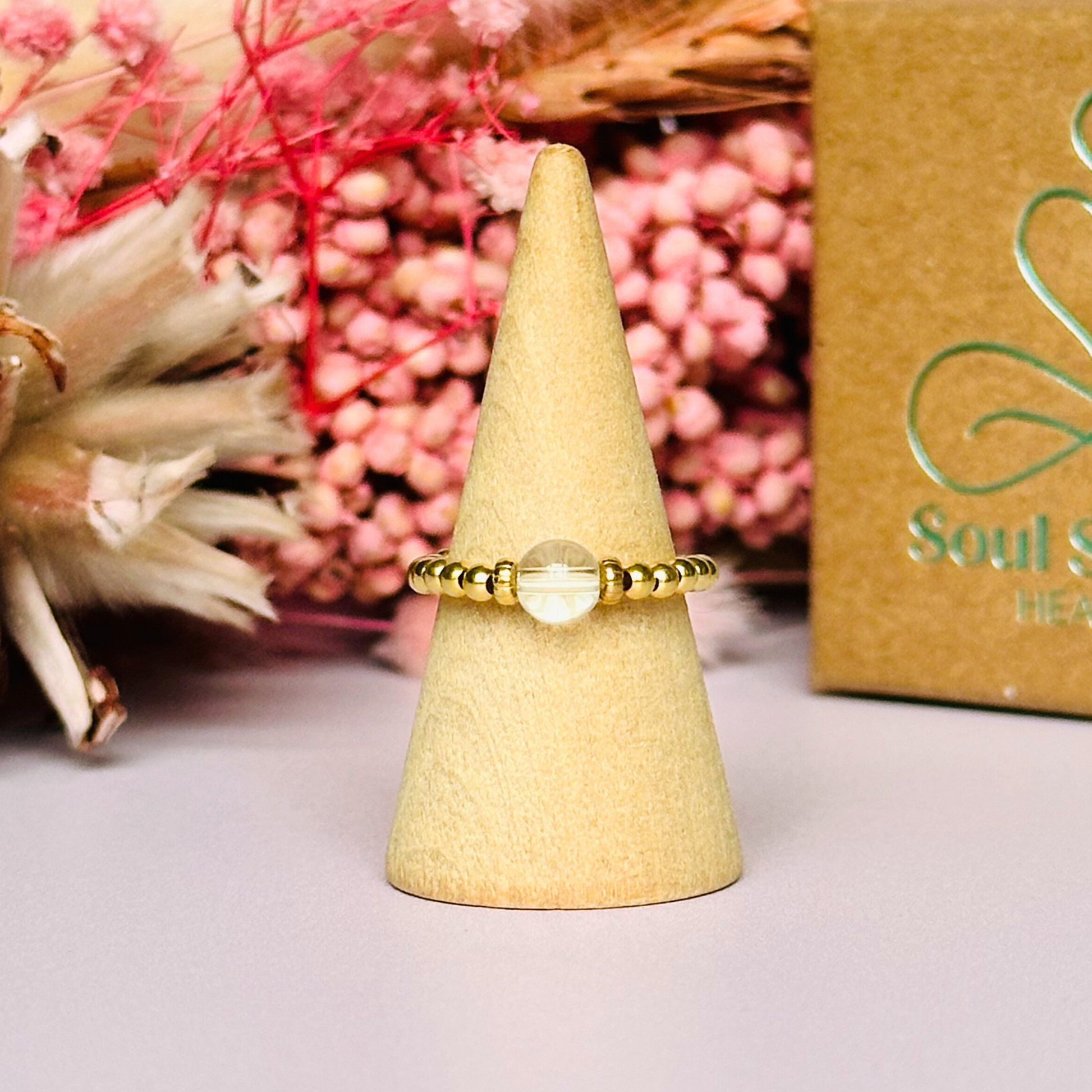 This gold vermeil clear quartz ring features a 6mm round ethically sourced clear quartz bead, surrounded by gold vermeil corrugated rondelle beads and delicate 2.5mm gold vermeil beads. April birthstone ring.