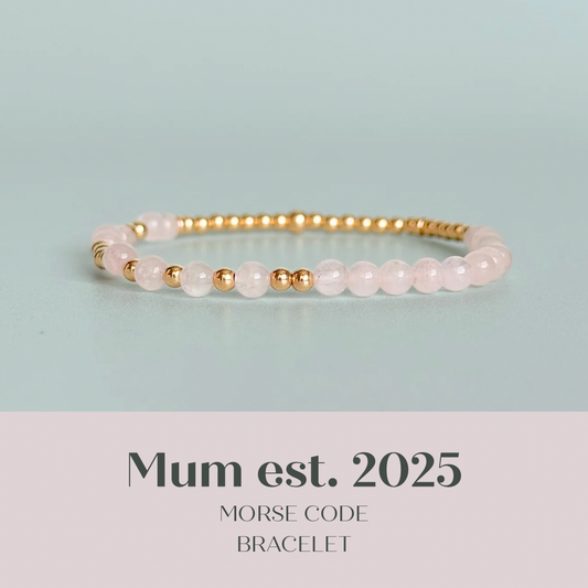 Morse code secret message bracelet spelling out the words Mum est. 2025 in gold filled and rose quartz crystal beads. elasticated with 4mm rose quartz beads and 3mm gold filled beads.