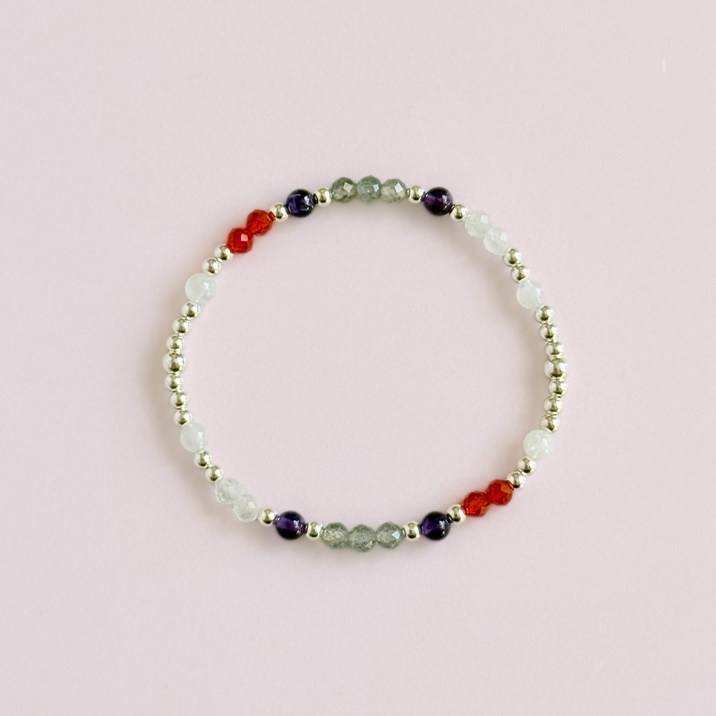 Dainty sterling silver crystal bracelet featuring five crystals, in 4mm faceted and smooth round style, each believed to help with hormonal balance. Featuring amethyst, moonstone, carnelian, labradorite and rose quartz. Pictured from above.