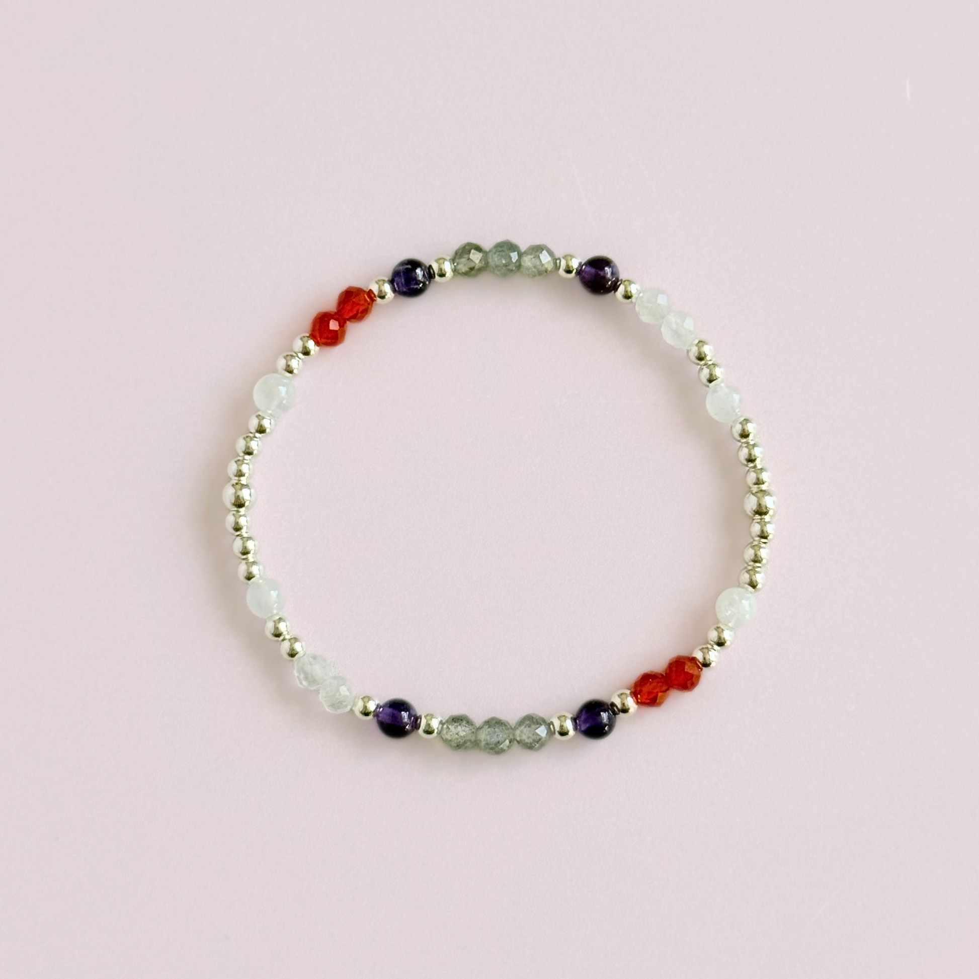 Dainty sterling silver crystal bracelet featuring five crystals, in 4mm faceted and smooth round style, each believed to help with hormonal balance. Featuring amethyst, moonstone, carnelian, labradorite and rose quartz. Pictured from above.
