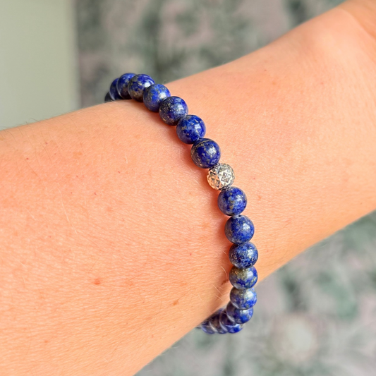 Genuine lapis lazuli bracelet featuring 6mm, smooth, round dark blue lapis lazuli beads and your choice of￼ a 6mm faceted gold vermeil or sterling silver￼ accent bead. Elasticated for comfort.