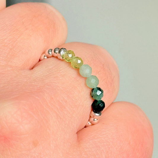 Sterling silver band style ombré ring with multicolour 3mm faceted peridot, green aventurine and emerald beads with a beaded band of 2.5 mm sterling silver round beads. Elasticated for comfort.