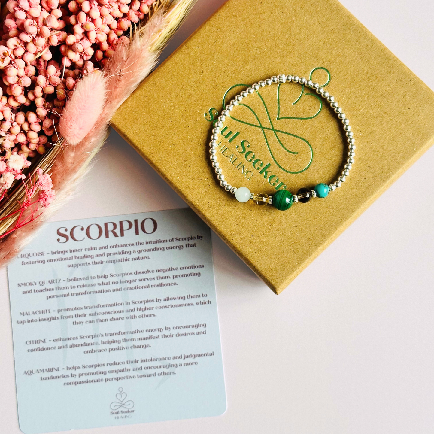This sterling silver Scorpio bracelet is made with a selection of five healing crystals all believed to resonate with the Scorpio zodiac sign. The central bead is 8mm, the other four are 6mm. On an elasticated band of 3mm sterling silver beads with corrugated accent beads. Featuring aquamarine, citrine, malachite, smoky quartz and turquoise.