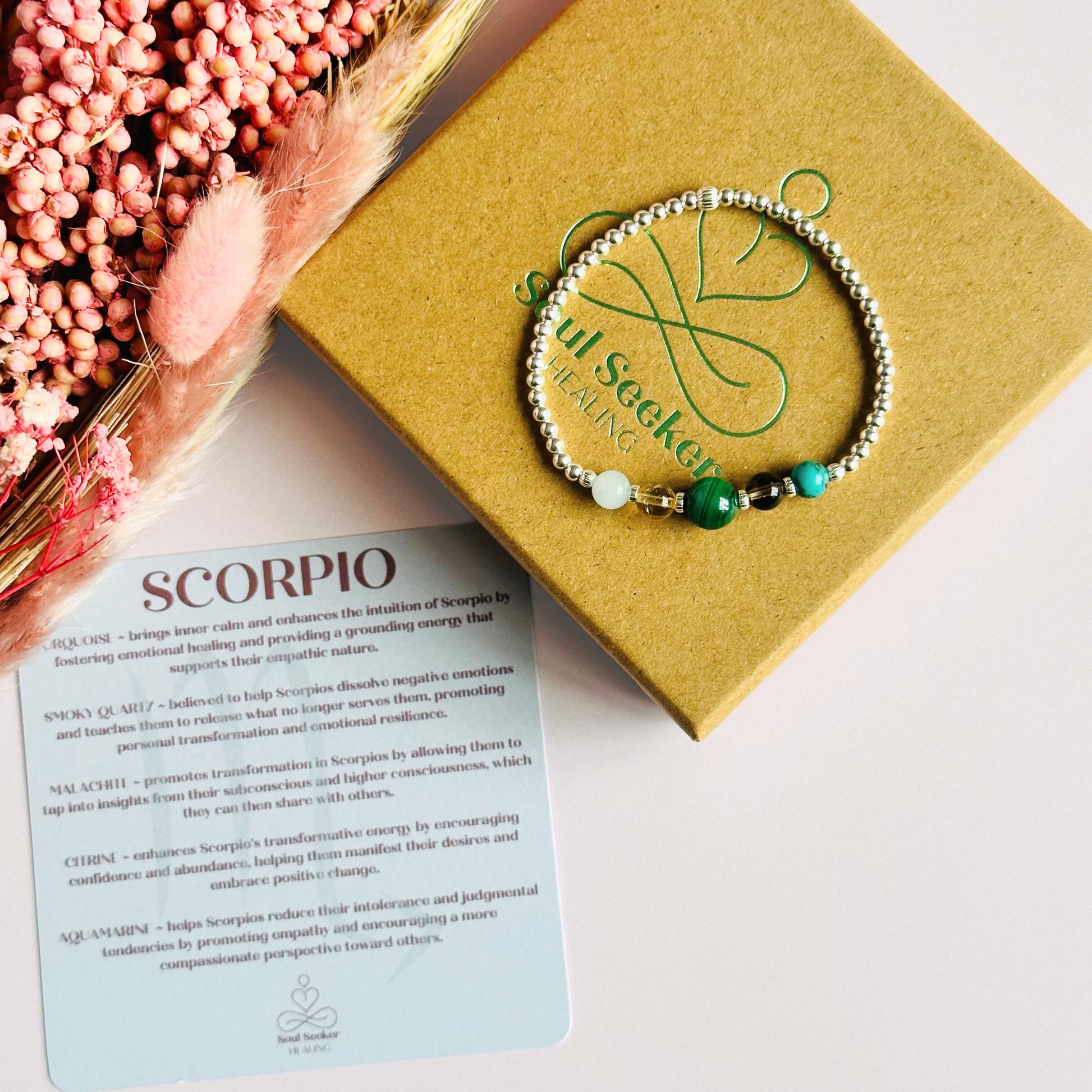This sterling silver Scorpio bracelet is made with a selection of five healing crystals all believed to resonate with the Scorpio zodiac sign. The central bead is 8mm, the other four are 6mm. On an elasticated band of 3mm sterling silver beads with corrugated accent beads. Featuring aquamarine, citrine, malachite, smoky quartz and turquoise.