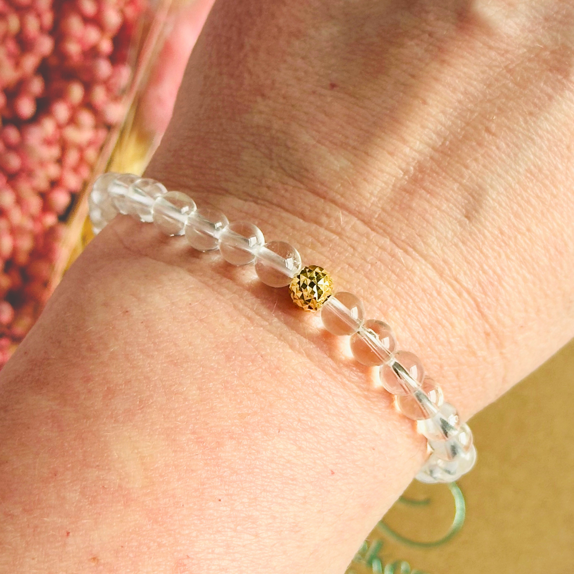 Clear quartz bracelet featuring 6mm round clear quartz beads with either a sterling silver or gold vermeil faceted focal bead