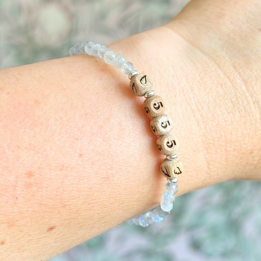 Bracelet featuring engraved wooden 555 angel number and wing beads, on the band of 4mm faceted labradorite round crystal gemstone beads. Finished with your choice of gold vermeil, sterling silver or rose gold vermeil accent beads.