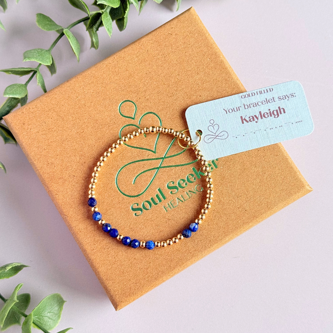 Morse code secret message bracelet spelling out your chosen name in gold filled and lapis lazuli crystal beads. Elasticated with 4mm faceted lapis lazuli beads and 3mm gold filled beads. Custom September birthstone bracelet.