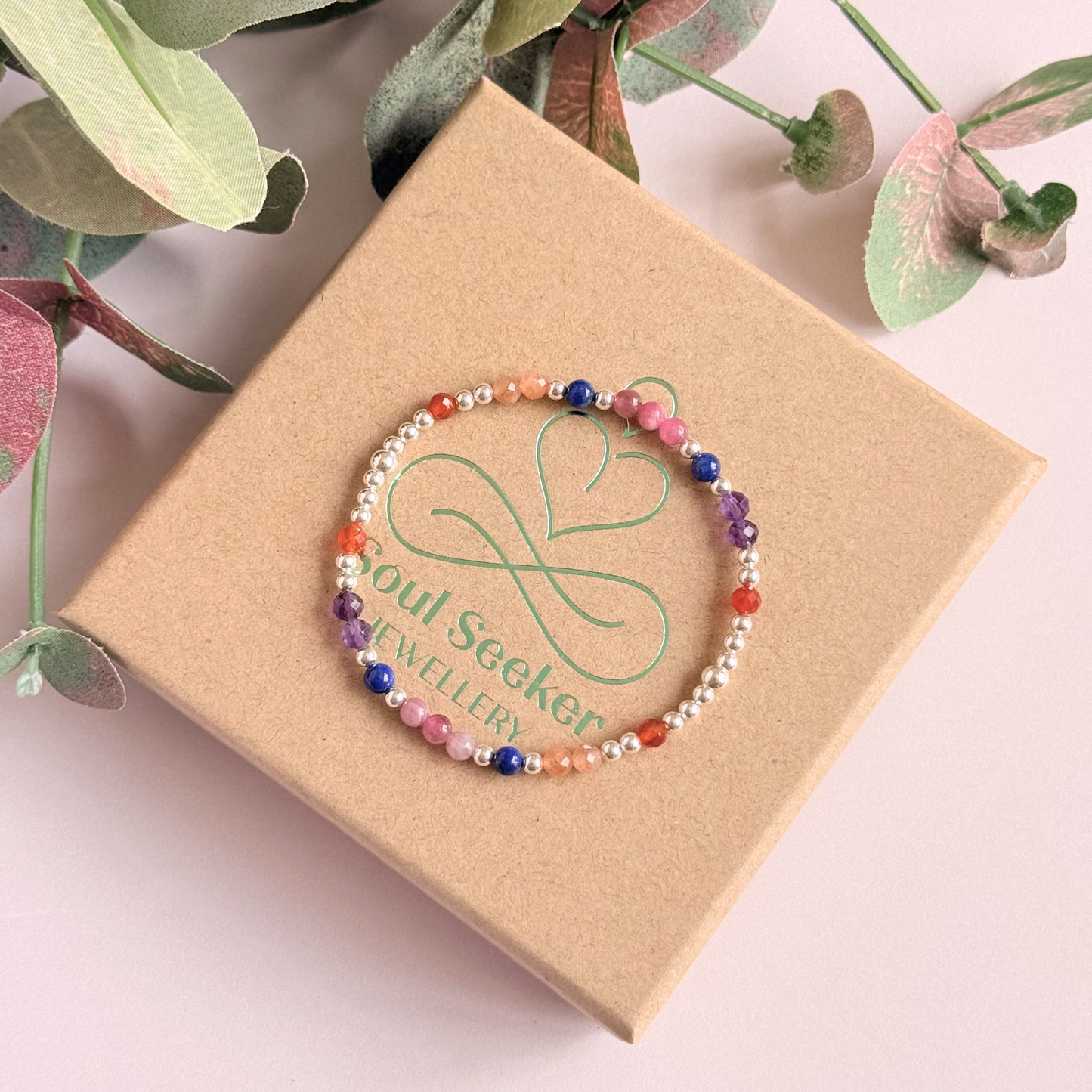 ‘Arabian Sunset' sterling silver dainty beaded bracelet with pink tourmaline, sunstone, carnelian, lapis lazuli and amethyst. Made with round 3mm sterling silver beads and 4mm smooth and faceted round crystal gemstone beads. Pictured on the gift box, from above