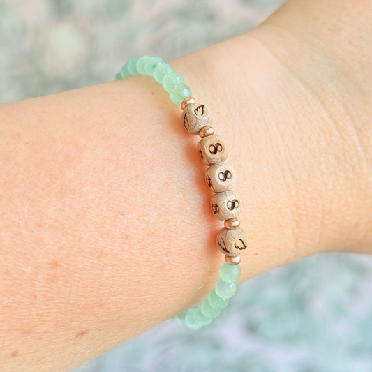 Bracelet featuring engraved wooden 888 angel number and wing beads, on the band of 4mm faceted green aventurine round crystal gemstone beads. Finished with your choice of gold vermeil, sterling silver or rose gold vermeil accent beads.