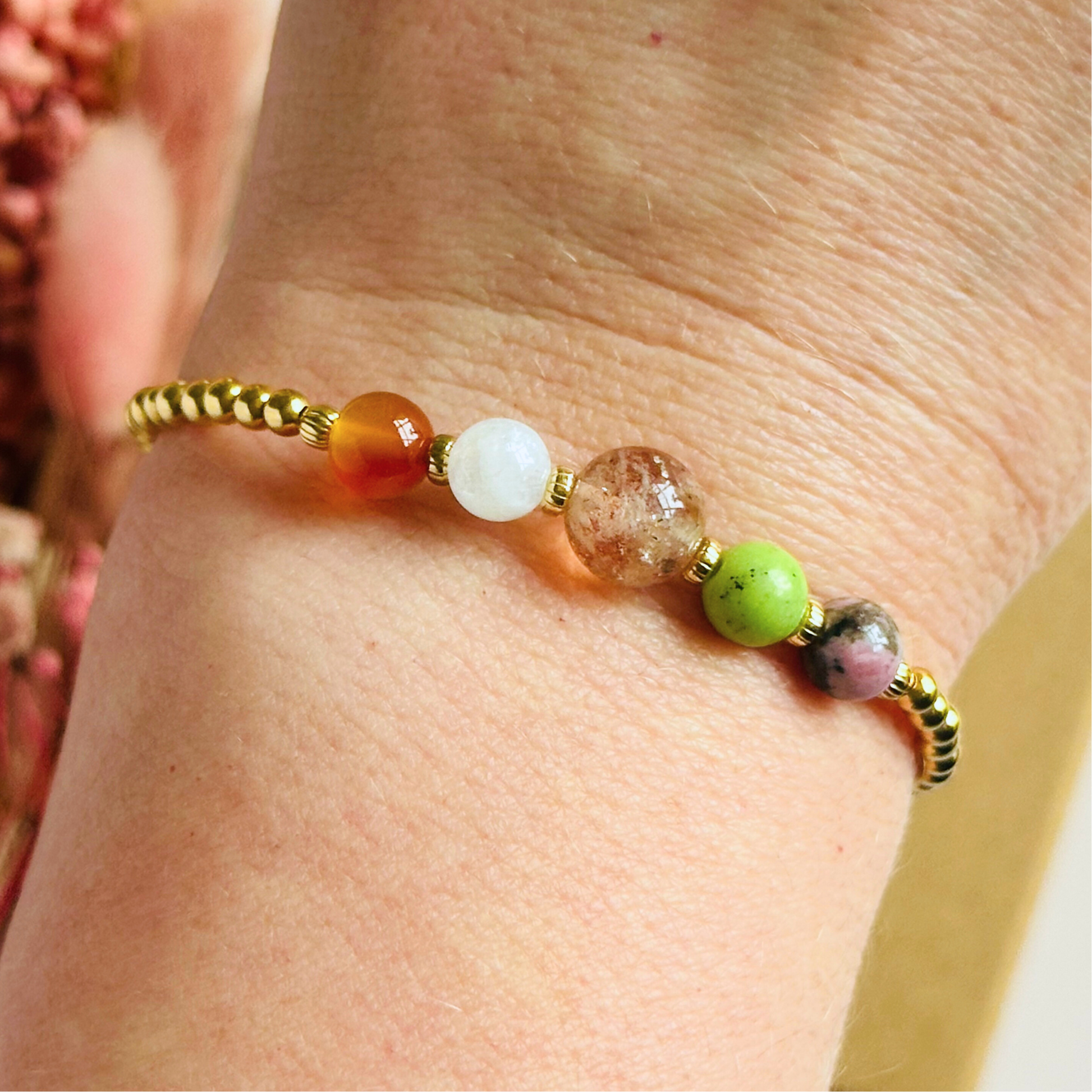 This gold vermeil Cancer bracelet is made with a selection of five healing crystals all believed to resonate with the Cancer zodiac sign. The central bead is 8mm, the other four are 6mm. On an elasticated band of 3mm gold vermeil beads with corrugated accent beads. Featuring chrysoprase, rhodonite, sunstone, moonstone and carnelian.