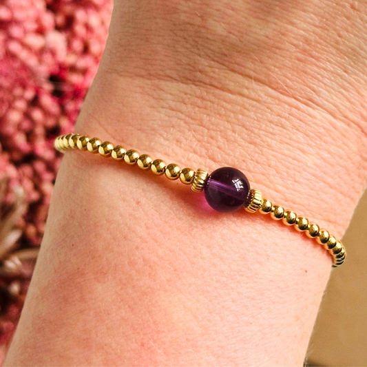 Gold vermeil amethyst bracelet features an ethically mined 8mm amethyst bead, flanked by corrugated rondelle beads on a band of 3mm gold vermeil beads. A bracelet to promote inner peace and calm.
