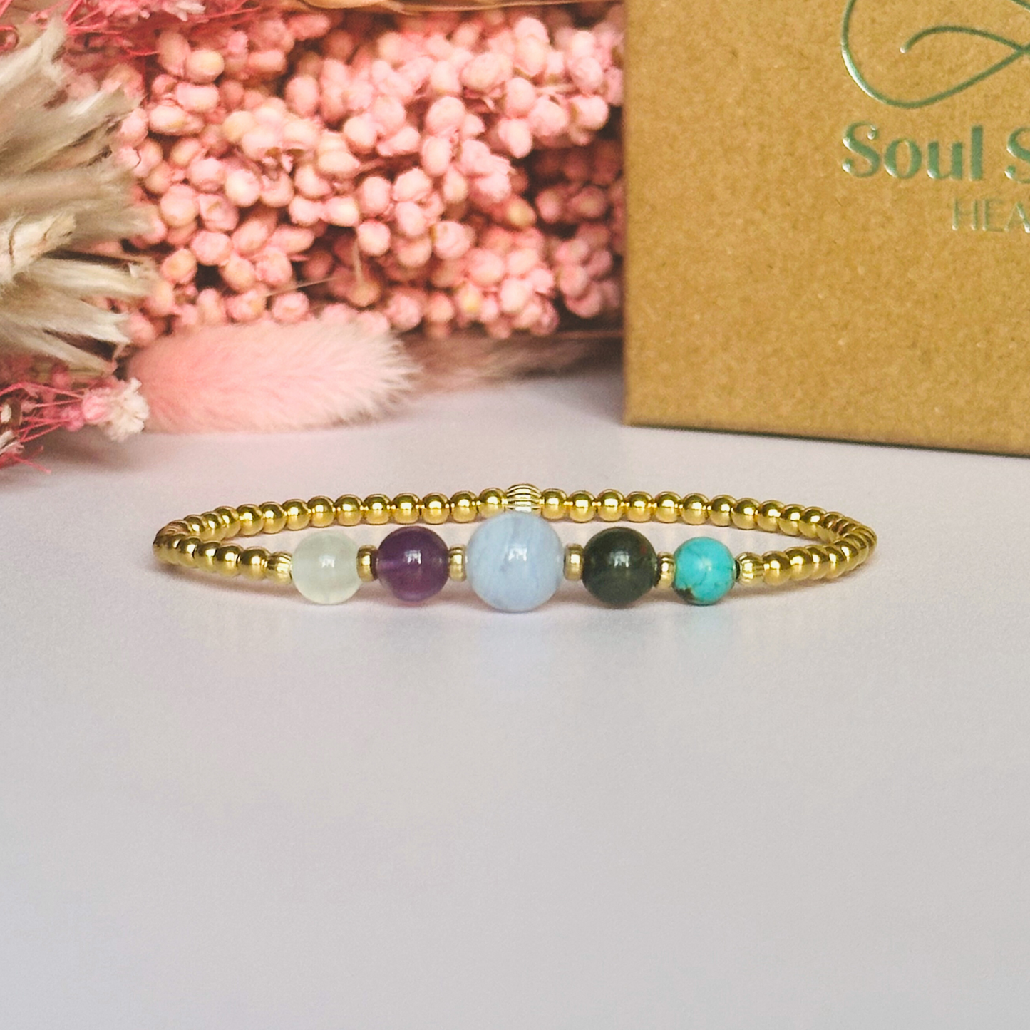 This gold vermeil Pisces bracelet is made with a selection of five healing crystals all believed to resonate with the Pisces zodiac sign. The central bead is 8mm, the other four are 6mm. On an elasticated band of 3mm gold vermeil beads with corrugated accent beads. Featuring turquoise, bloodstone, blue lace agate, amethyst and selenite.