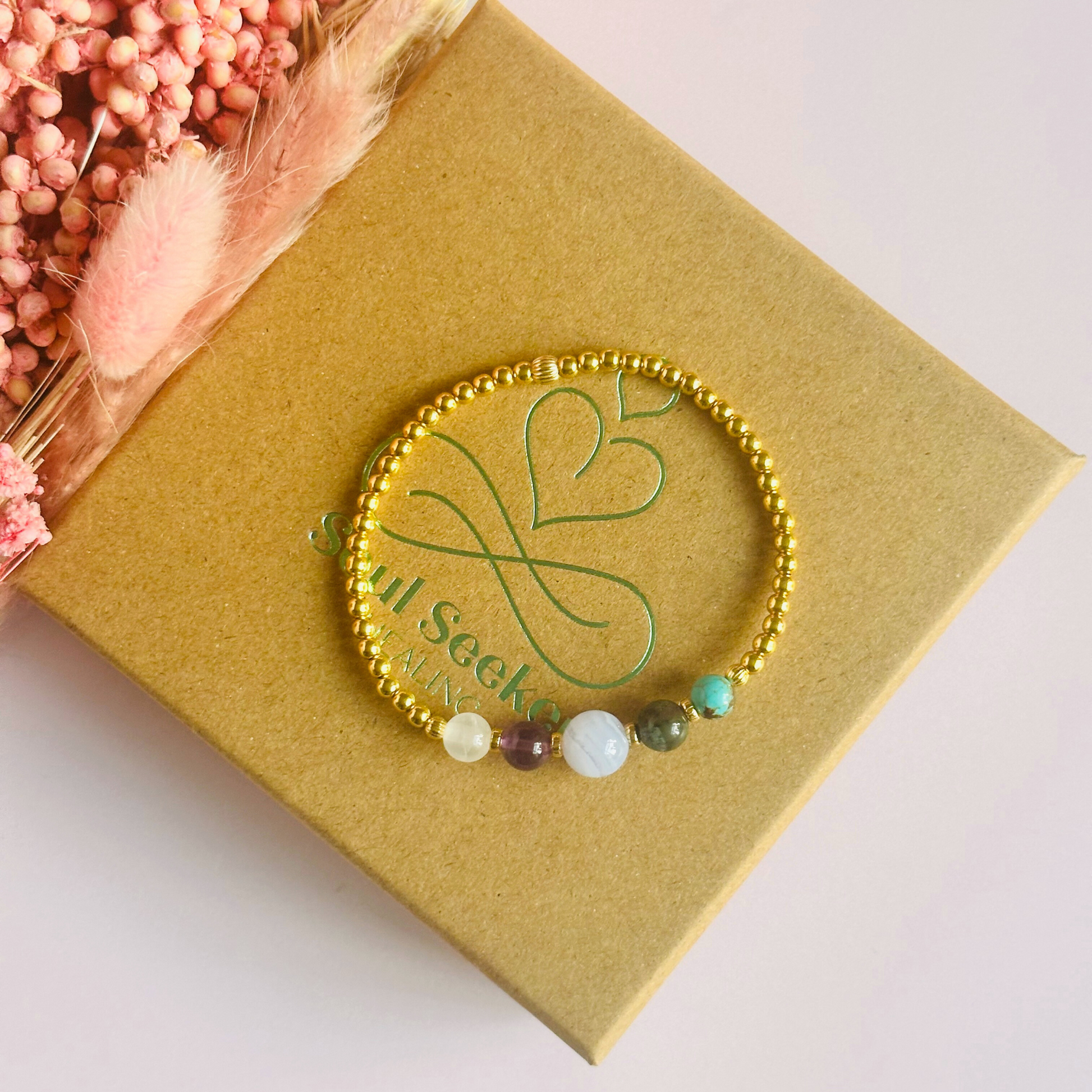 This gold vermeil Pisces bracelet is made with a selection of five healing crystals all believed to resonate with the Pisces zodiac sign. The central bead is 8mm, the other four are 6mm. On an elasticated band of 3mm gold vermeil beads with corrugated accent beads. Featuring turquoise, bloodstone, blue lace agate, amethyst and selenite.