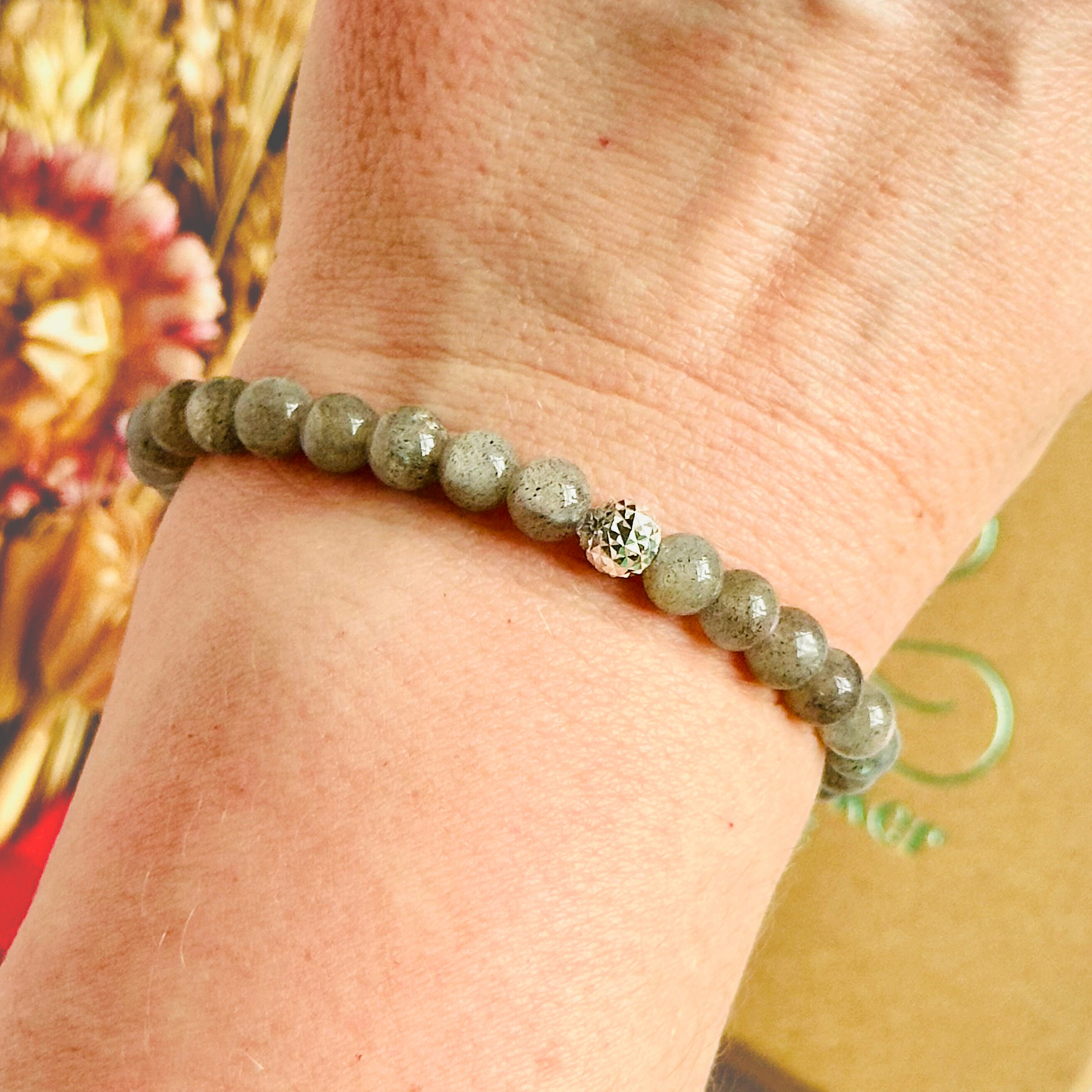 This labradorite bracelet is made with ethically mined labradorite smooth crystal beads and features your choice of a sterling silver or gold vermeil faceted focal bead. All beads are 6mm.