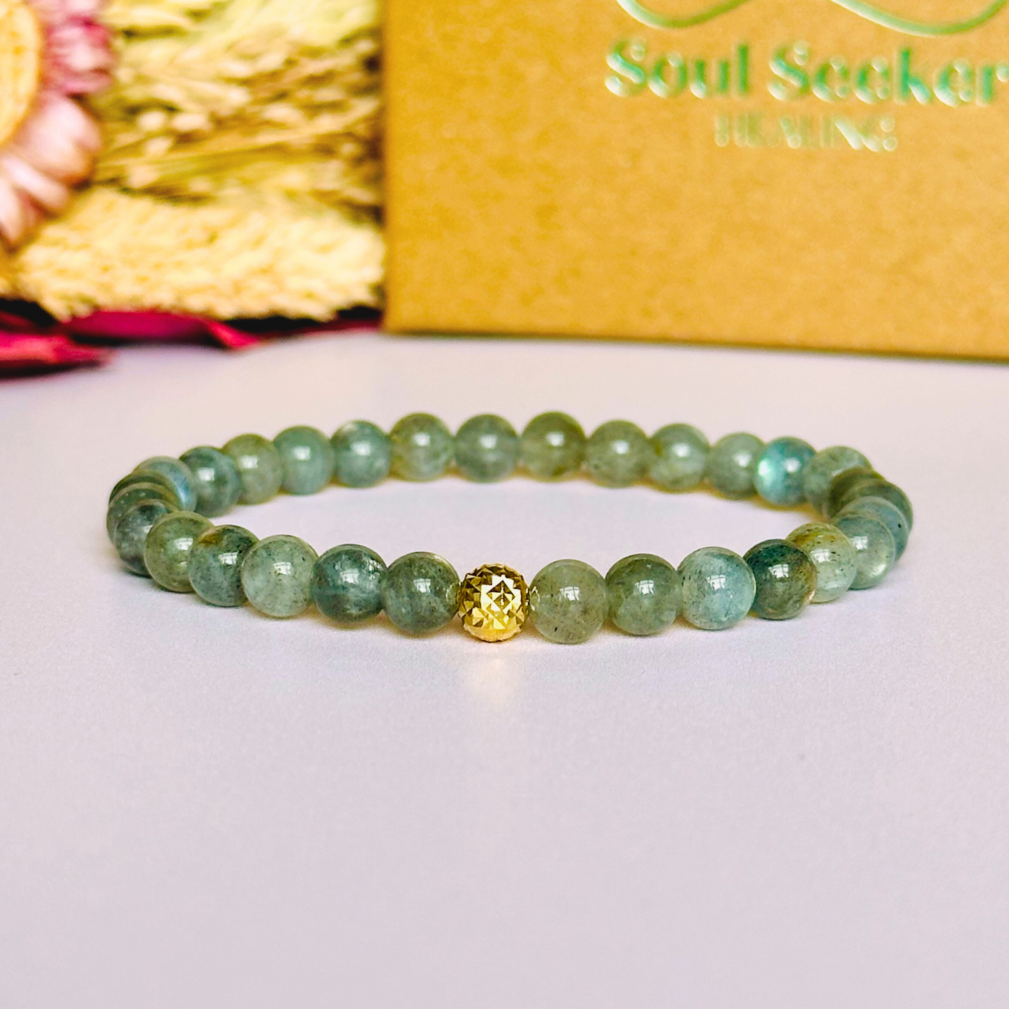 This labradorite bracelet is made with ethically mined labradorite smooth crystal beads and features your choice of a sterling silver or gold vermeil faceted focal bead. All beads are 6mm.