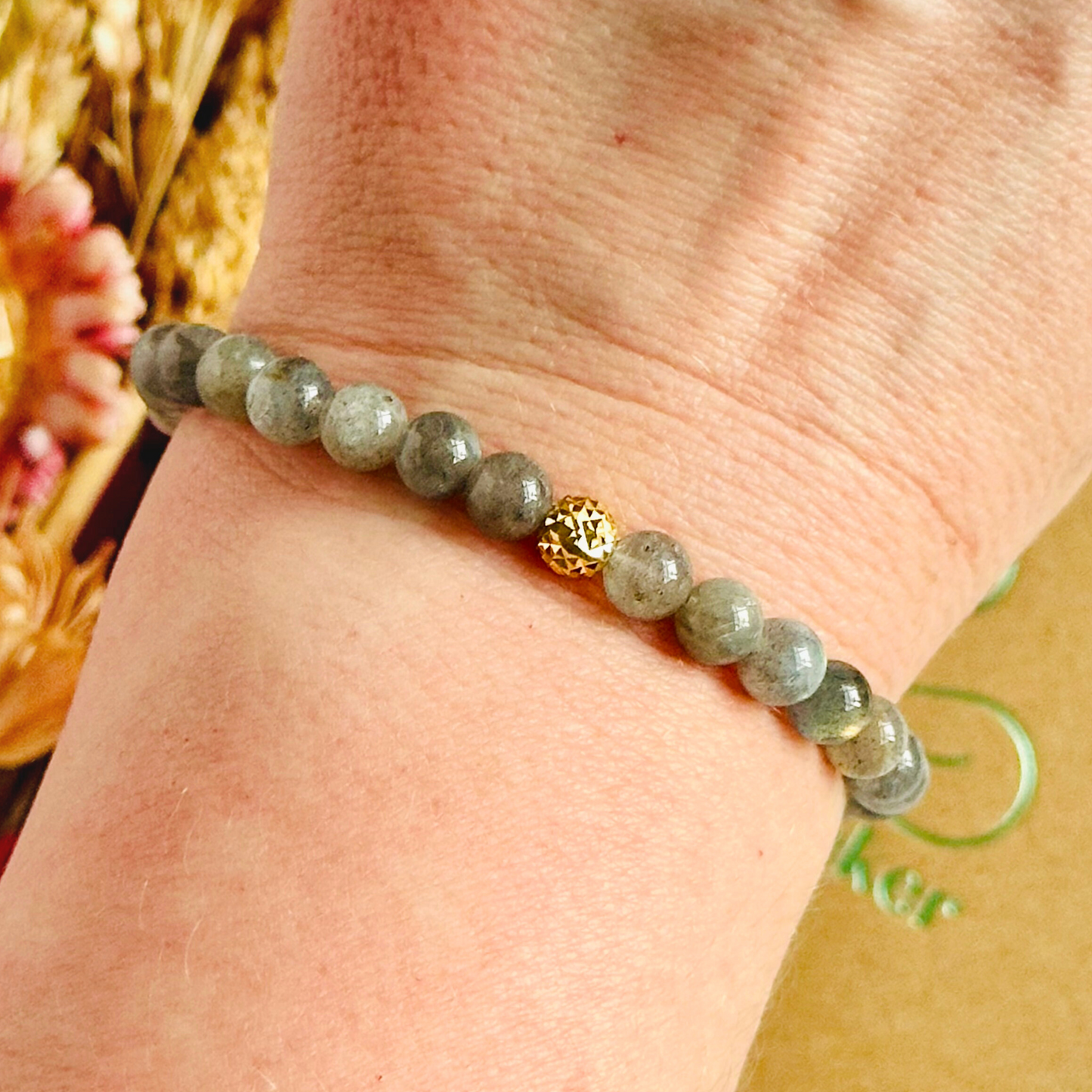 This labradorite bracelet is made with ethically mined labradorite smooth crystal beads and features your choice of a sterling silver or gold vermeil faceted focal bead. All beads are 6mm.