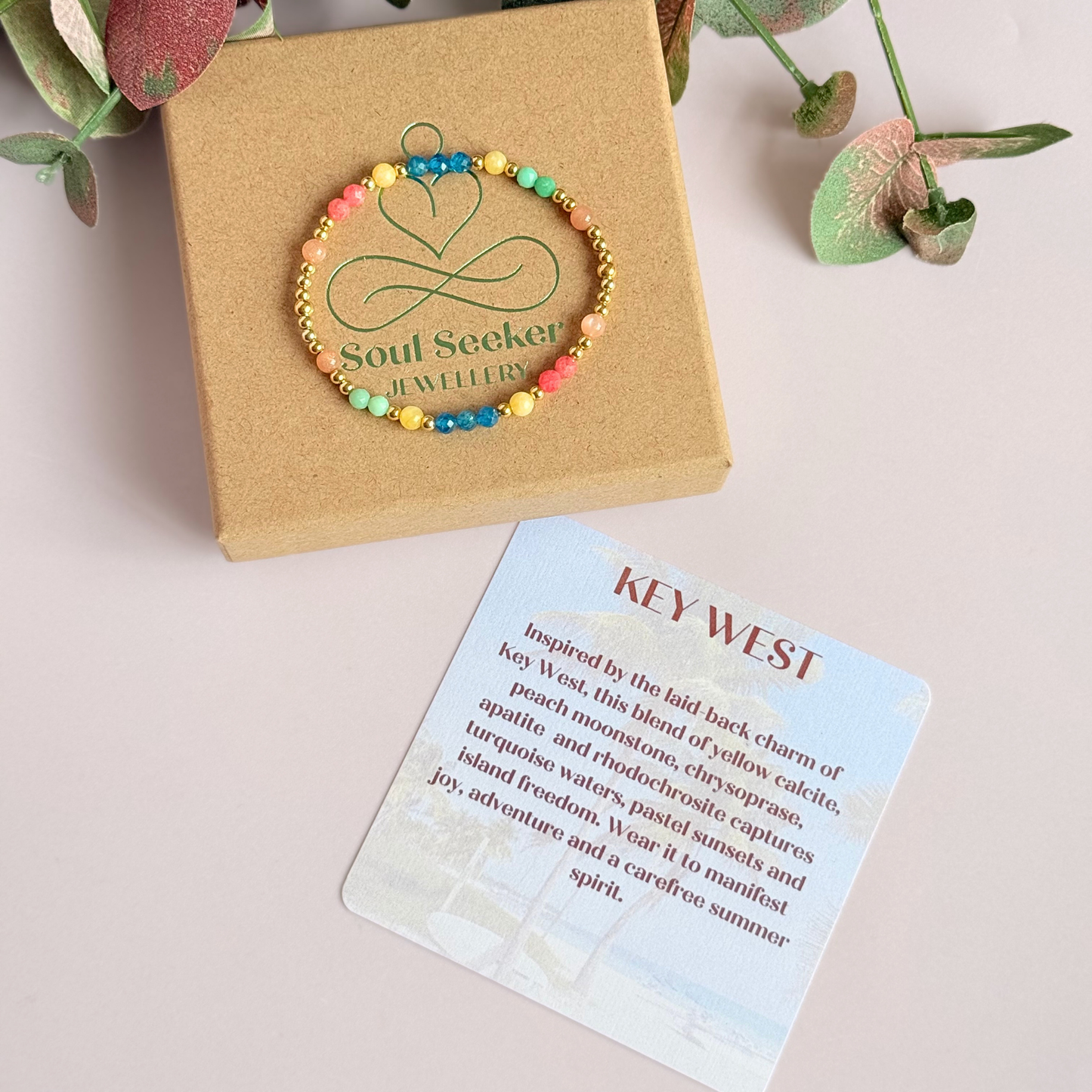 'Key West' gold vermeil dainty beaded bracelet with apatite, rhodochrosite, yellow calcite, chrysoprase and peach moonstone. Made with round 3mm gold vermeil beads and 4mm smooth and faceted round crystal gemstone beads. Pictured on the box, with the crystal information card