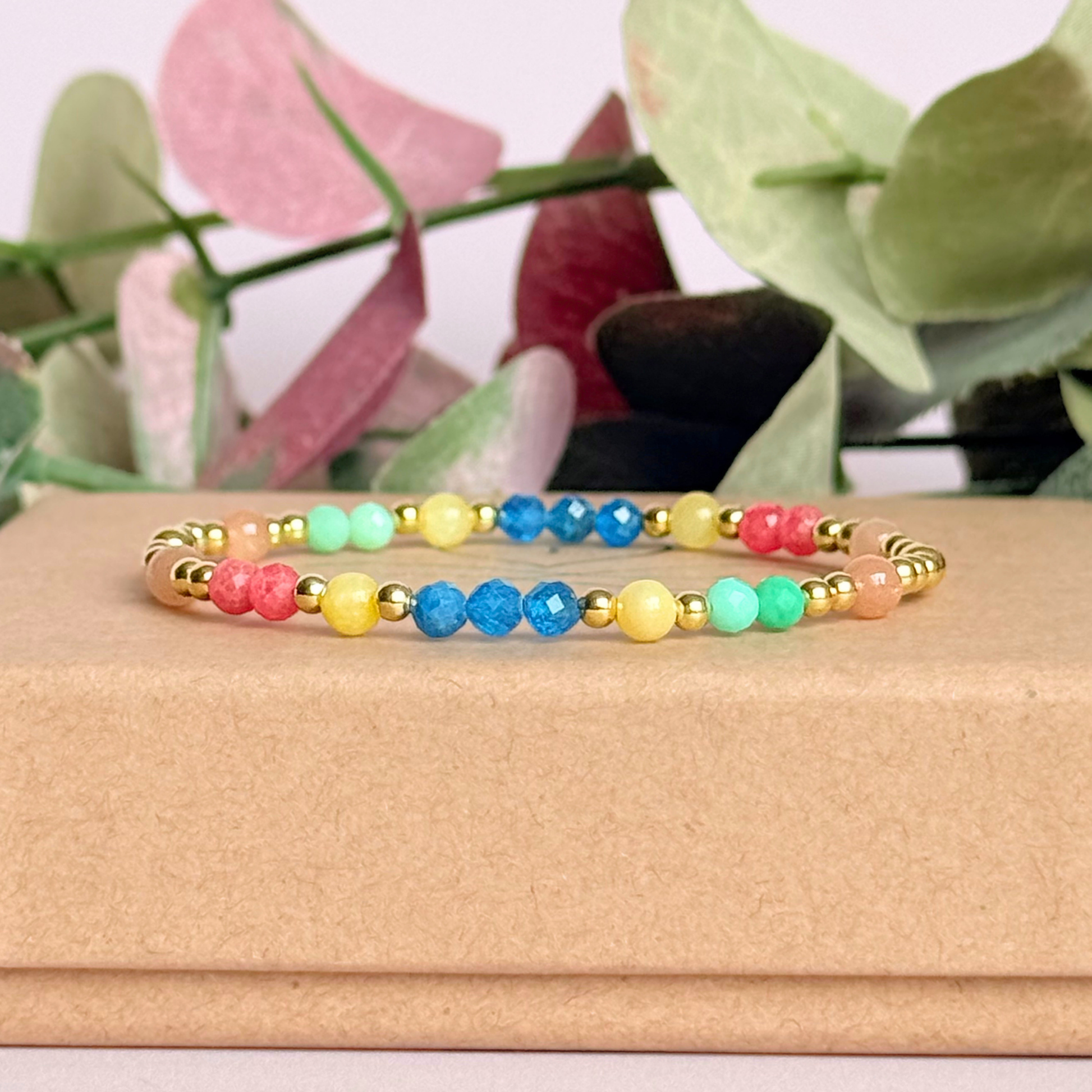 'Key West' gold vermeil dainty beaded bracelet with apatite, rhodochrosite, yellow calcite, chrysoprase and peach moonstone. Made with round 3mm gold vermeil beads and 4mm smooth and faceted round crystal gemstone beads. Pictured on top of the gift box