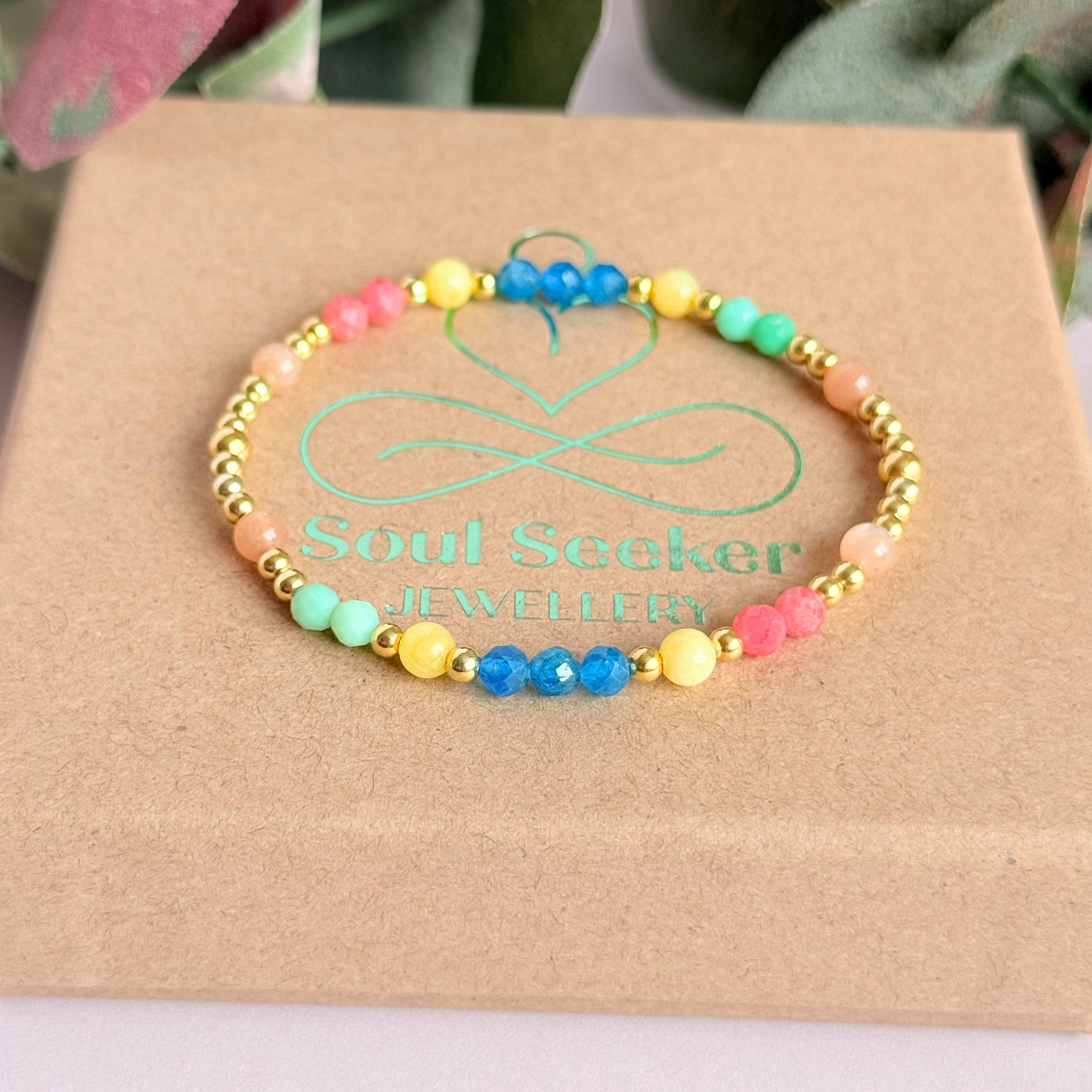 'Key West' gold vermeil dainty beaded bracelet with apatite, rhodochrosite, yellow calcite, chrysoprase and peach moonstone. Made with round 3mm gold vermeil beads and 4mm smooth and faceted round crystal gemstone beads. Pictured on the box