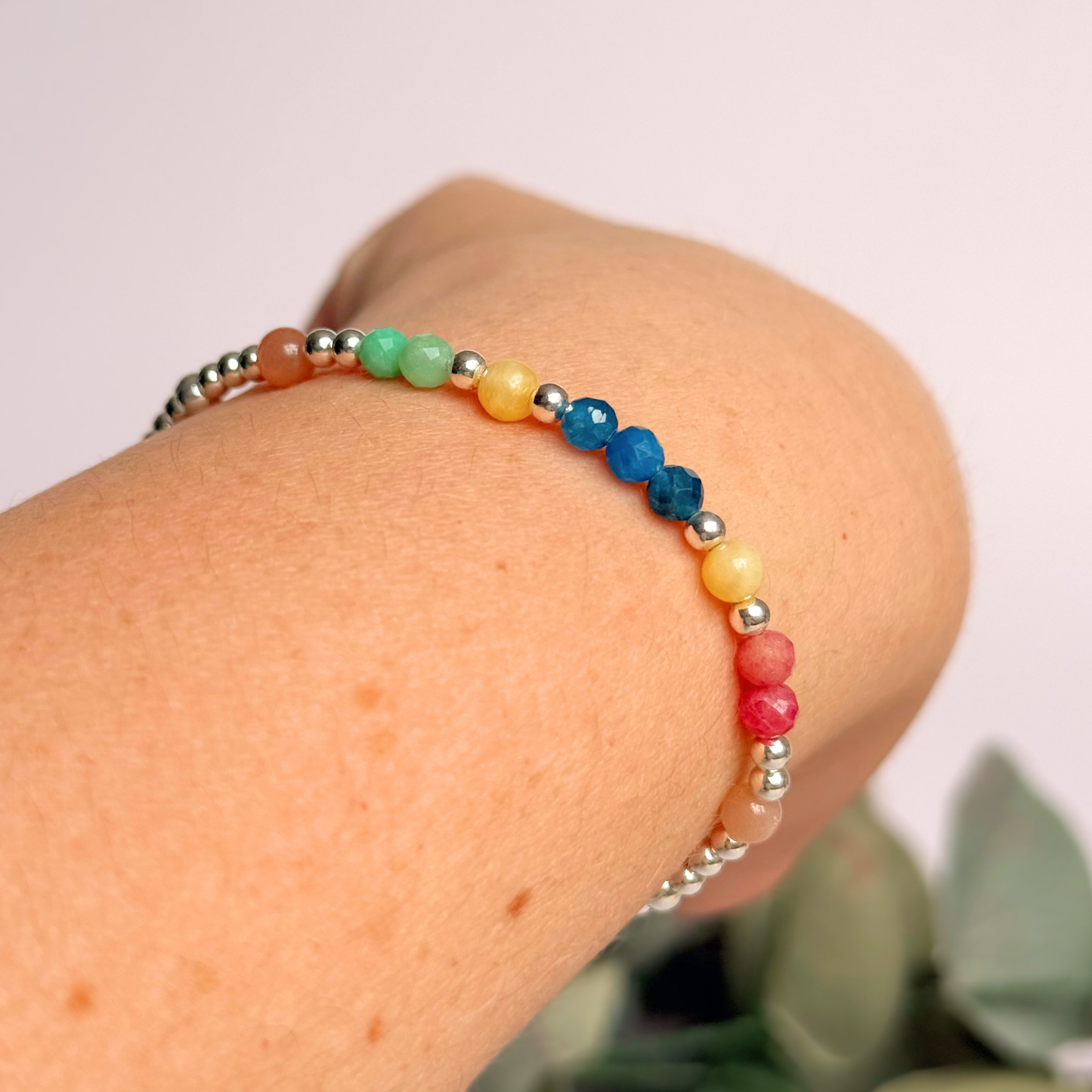 'Key West' sterling silver dainty beaded bracelet with apatite, rhodochrosite, yellow calcite, chrysoprase and peach moonstone. Made with round 3mm sterling silver beads and 4mm smooth and faceted round crystal gemstone beads. Pictured being worn, at an angle