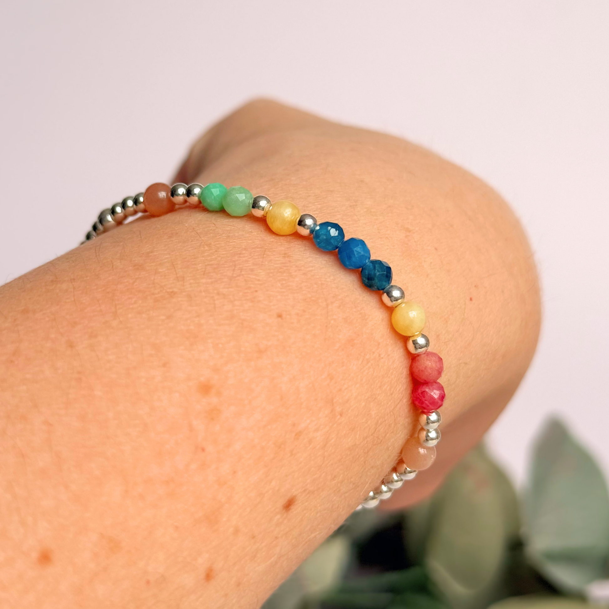 'Key West' sterling silver dainty beaded bracelet with apatite, rhodochrosite, yellow calcite, chrysoprase and peach moonstone. Made with round 3mm sterling silver beads and 4mm smooth and faceted round crystal gemstone beads. Pictured being worn, at an angle
